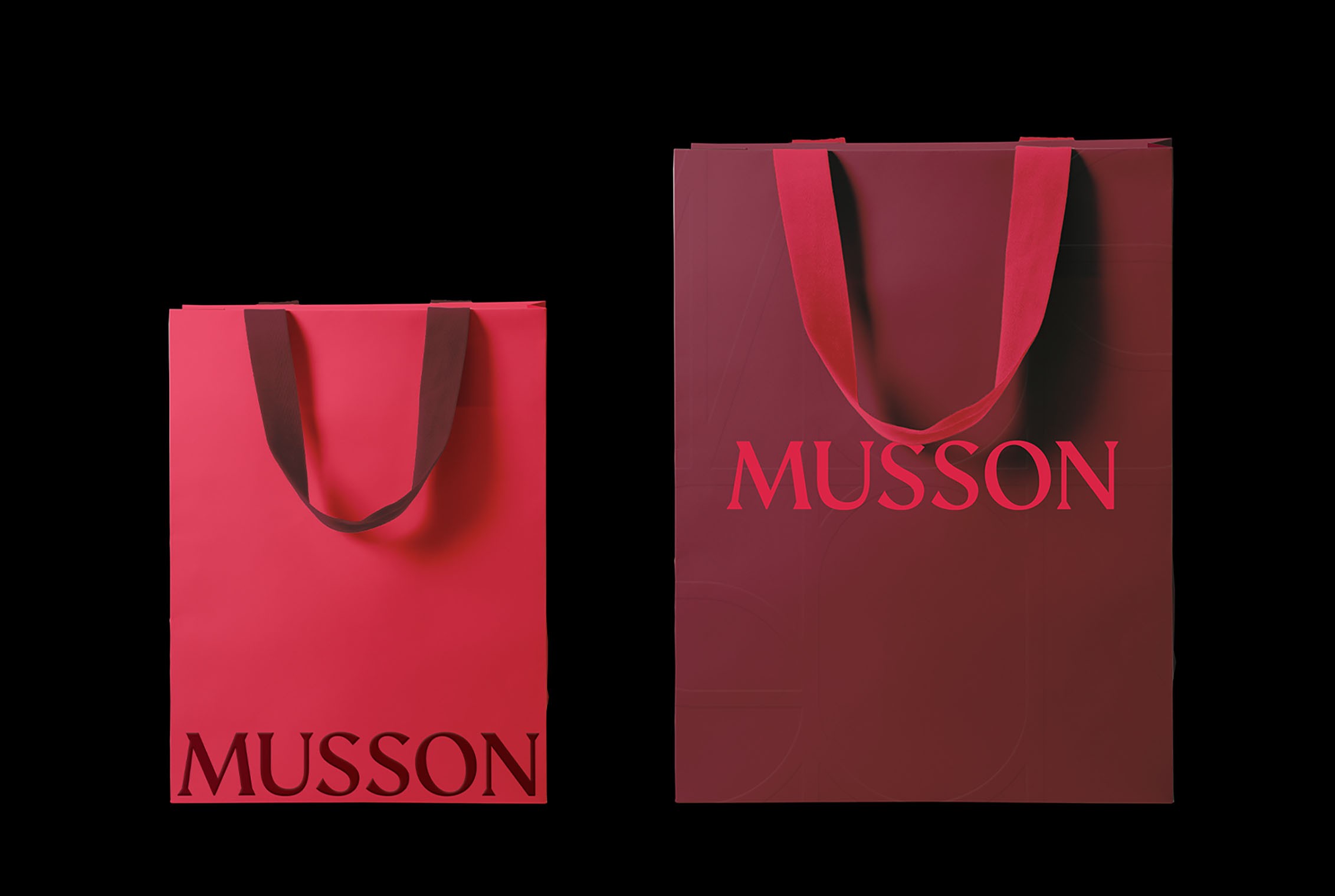 Two Musson shopping bags in crimson and deep burgundy with the serif logotype and ribbon handles