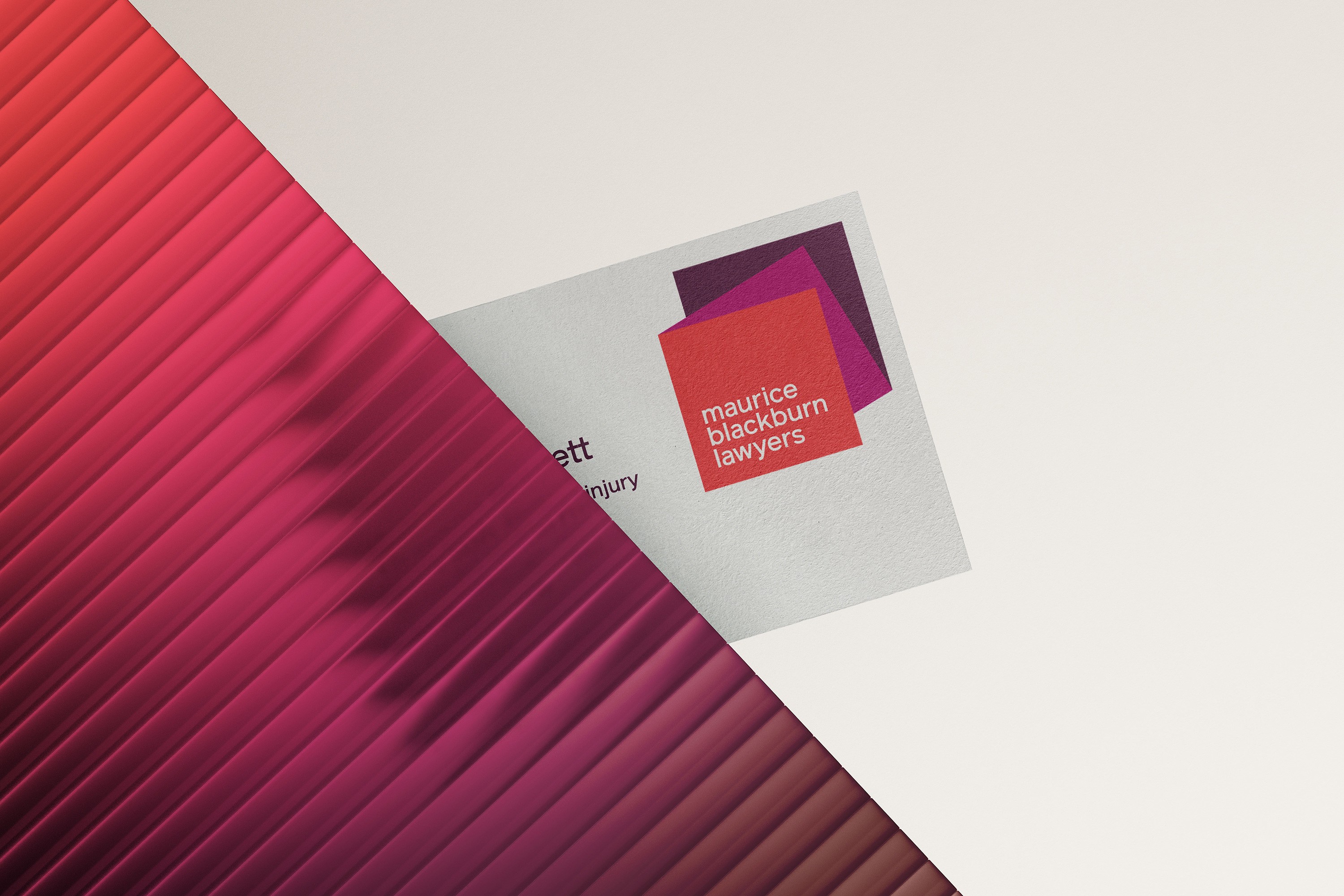 Maurice Blackburn business card with the layered square logo, on a rippled magenta backdrop