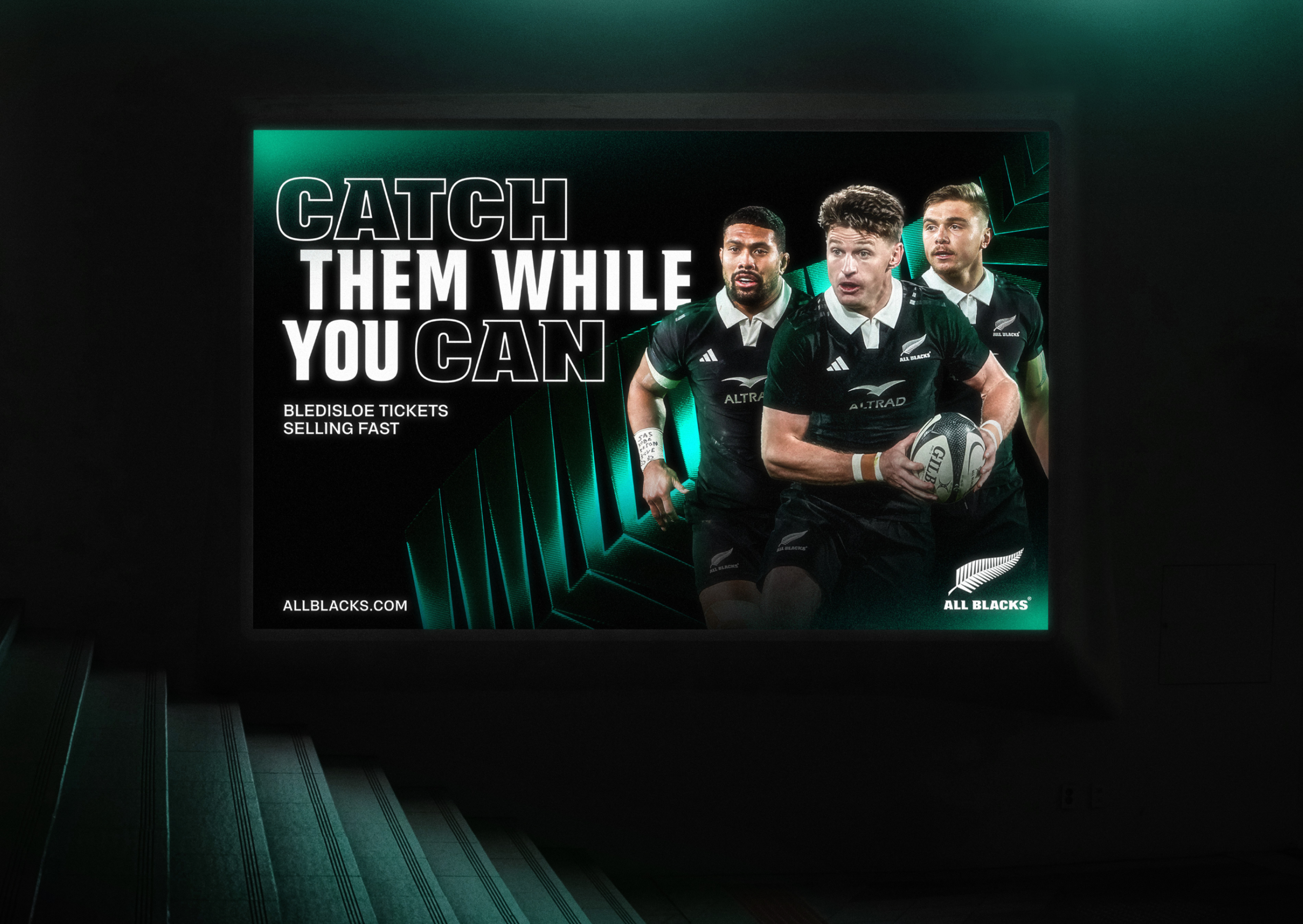 Illuminated billboard reading "Catch them while you can", Bledisloe ticket ad in green