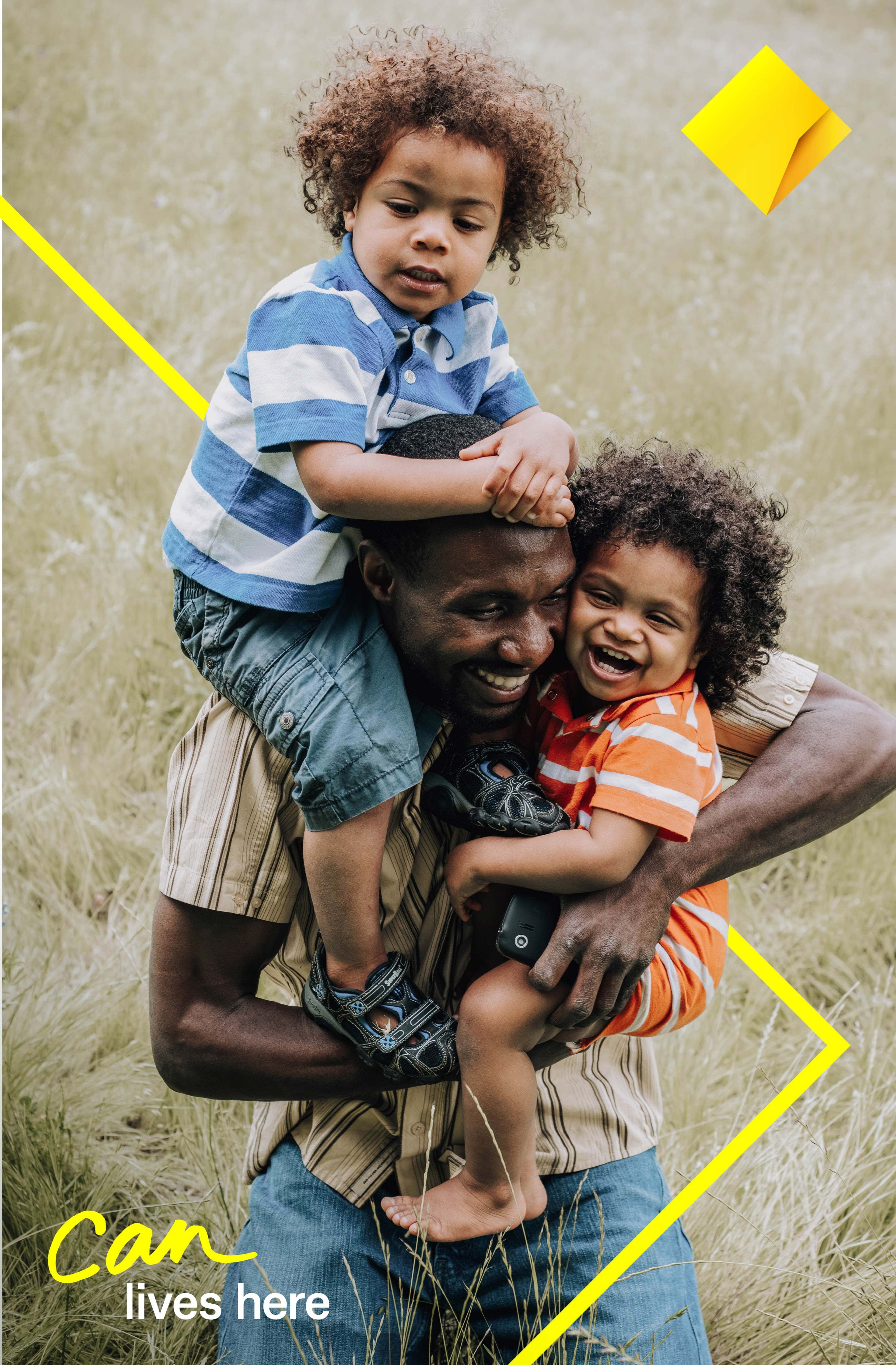 Campaign poster of a father carrying two laughing children, 'Can lives here' in yellow script