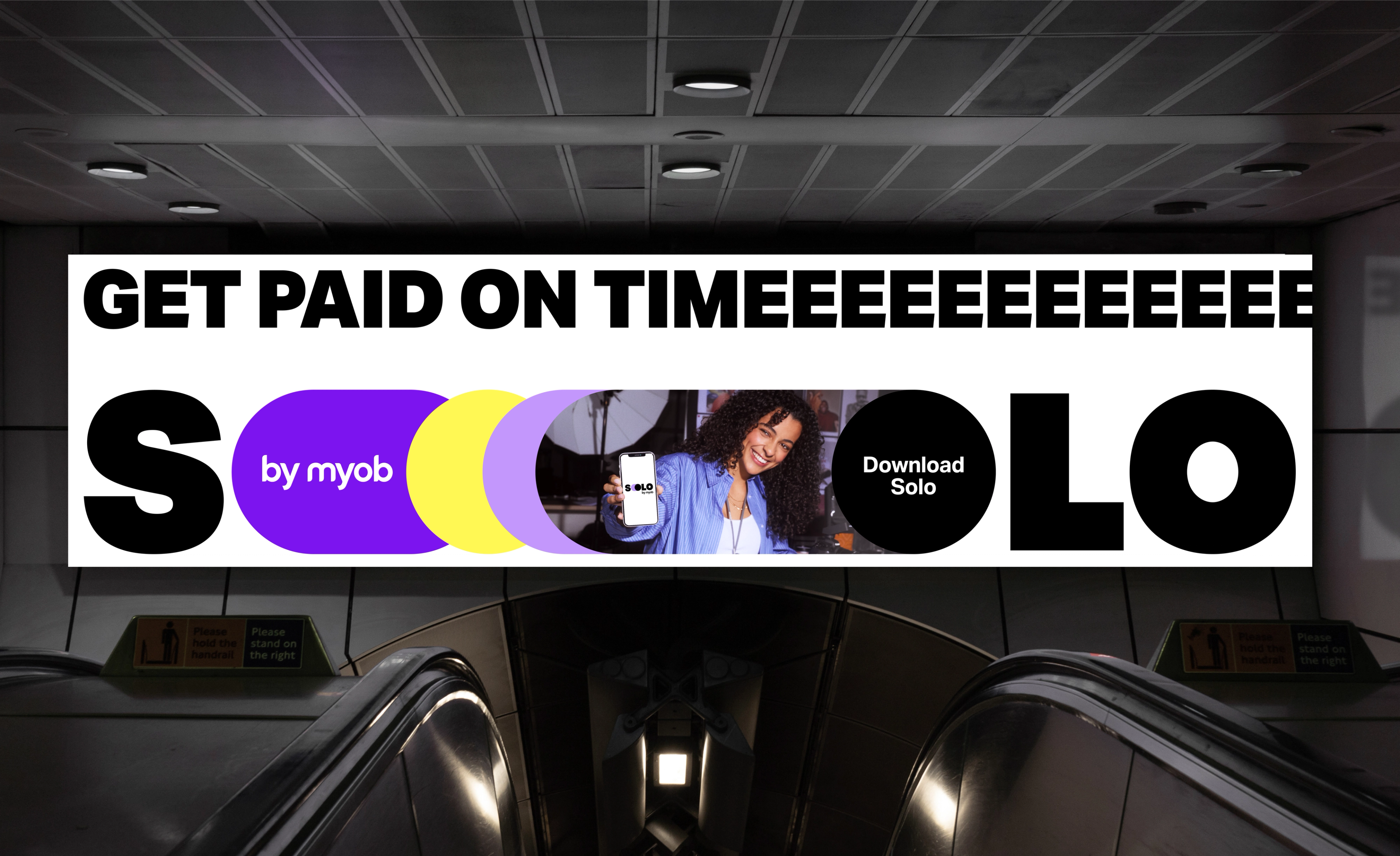 Escalator banner ad stretching 'Get paid on timeeee' across the Solo by MYOB wordmark