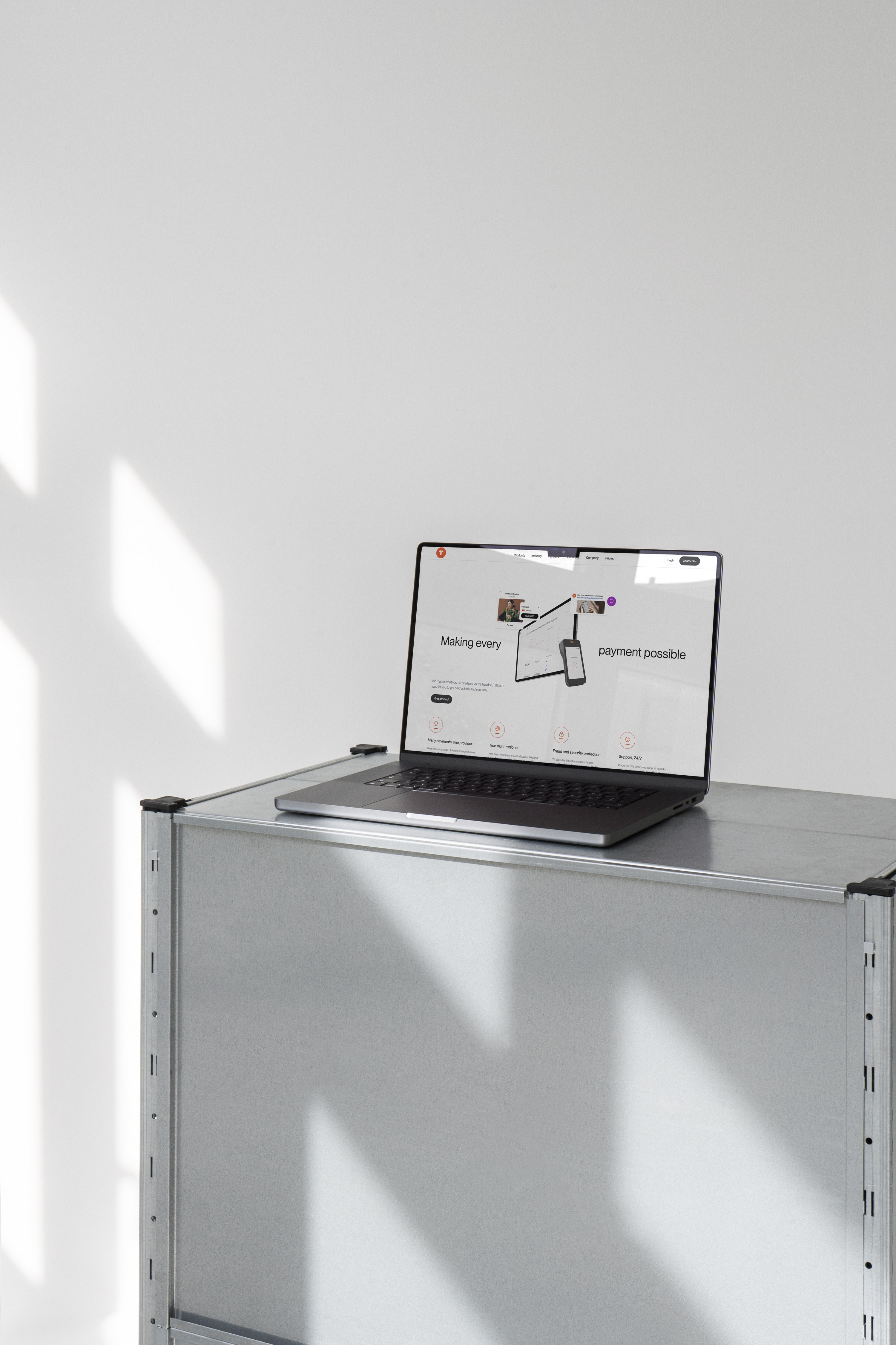 Laptop on a metal shelf showing the Till Payments homepage headline, Making every payment possible