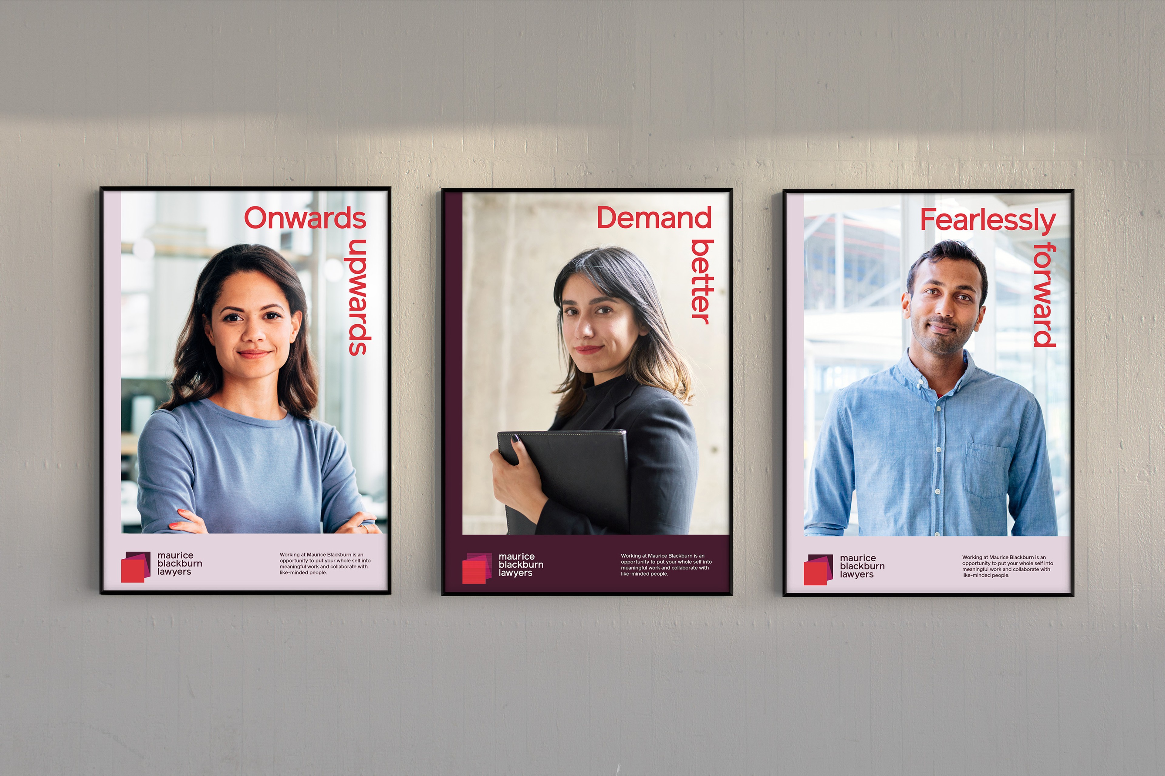 Three framed Maurice Blackburn recruitment posters with staff portraits and vertical red headlines