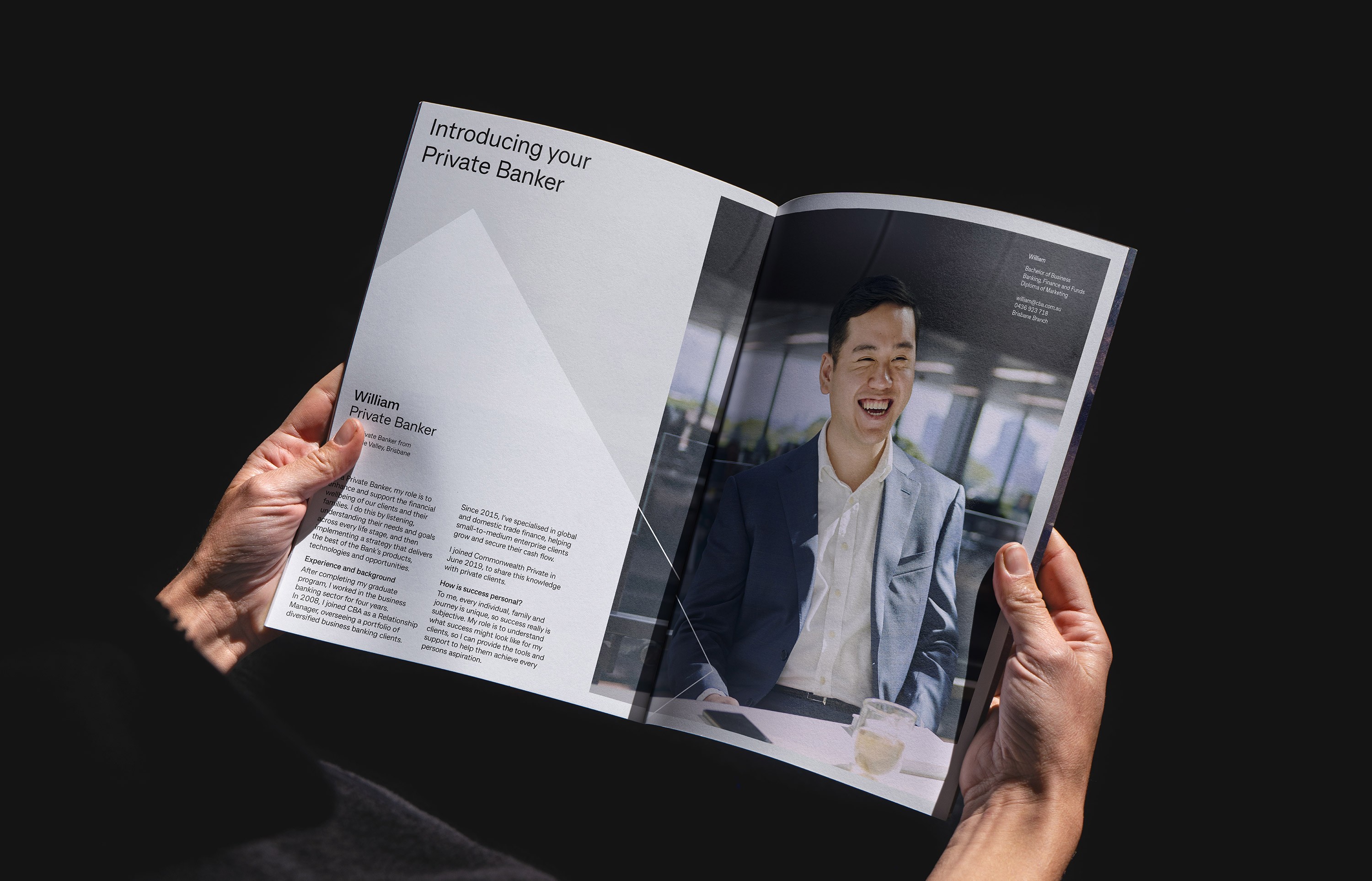 Hands holding open a private banking brochure, editorial portrait facing body copy