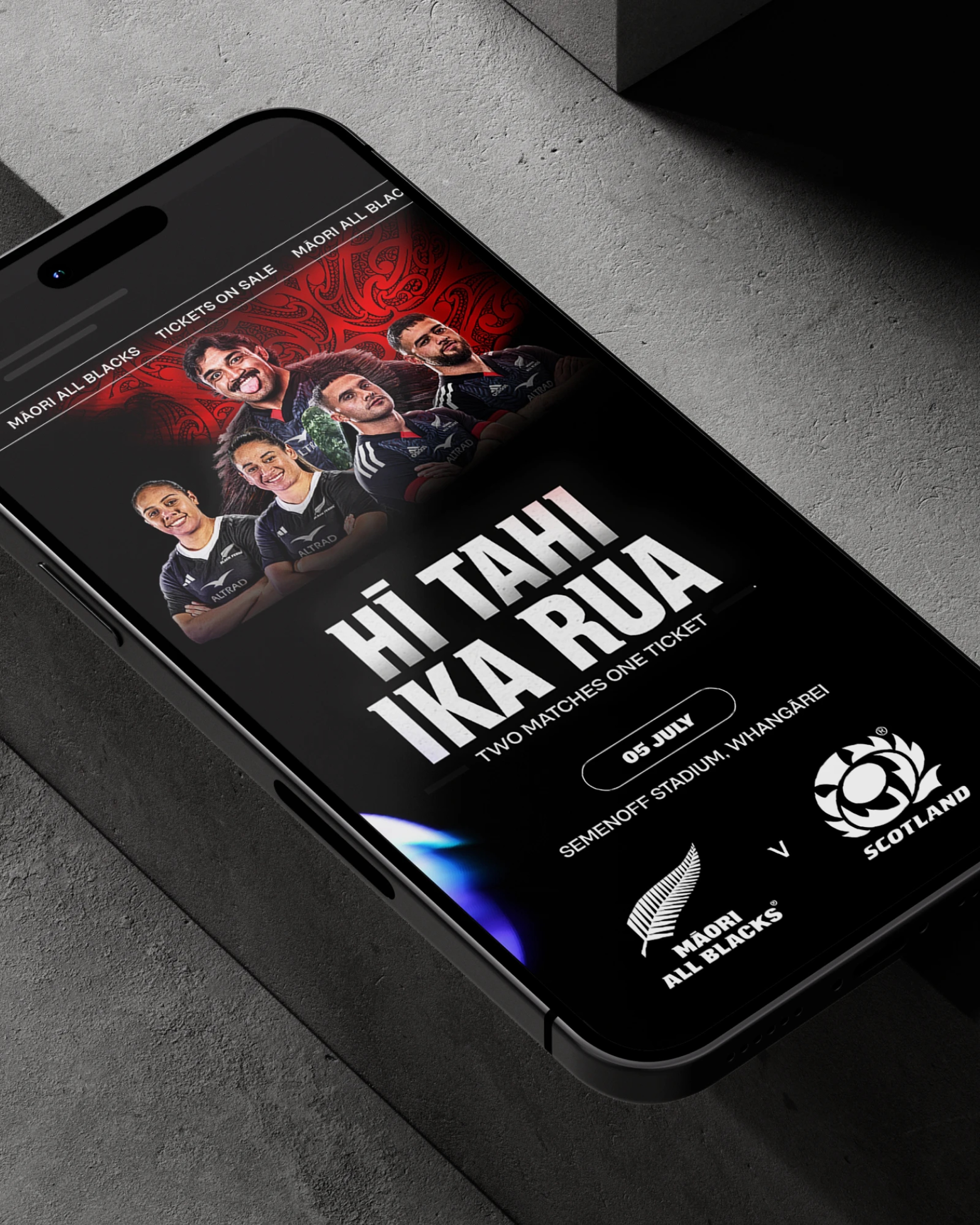 Phone screen with a Māori All Blacks v Scotland ticket page, headline "Hī tahi ika rua"