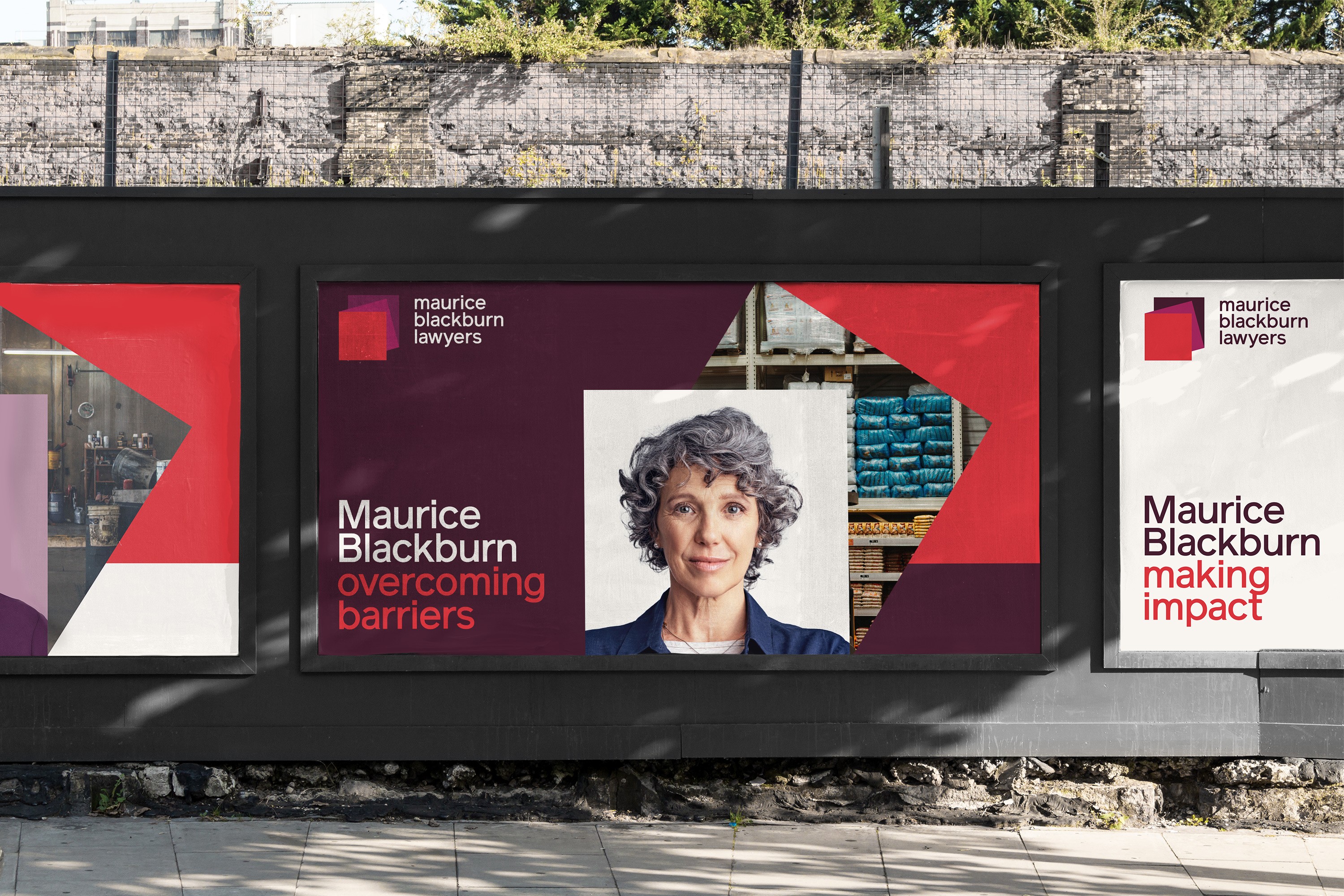 Street hoarding posters reading 'Maurice Blackburn overcoming barriers' and 'making impact', with portraits