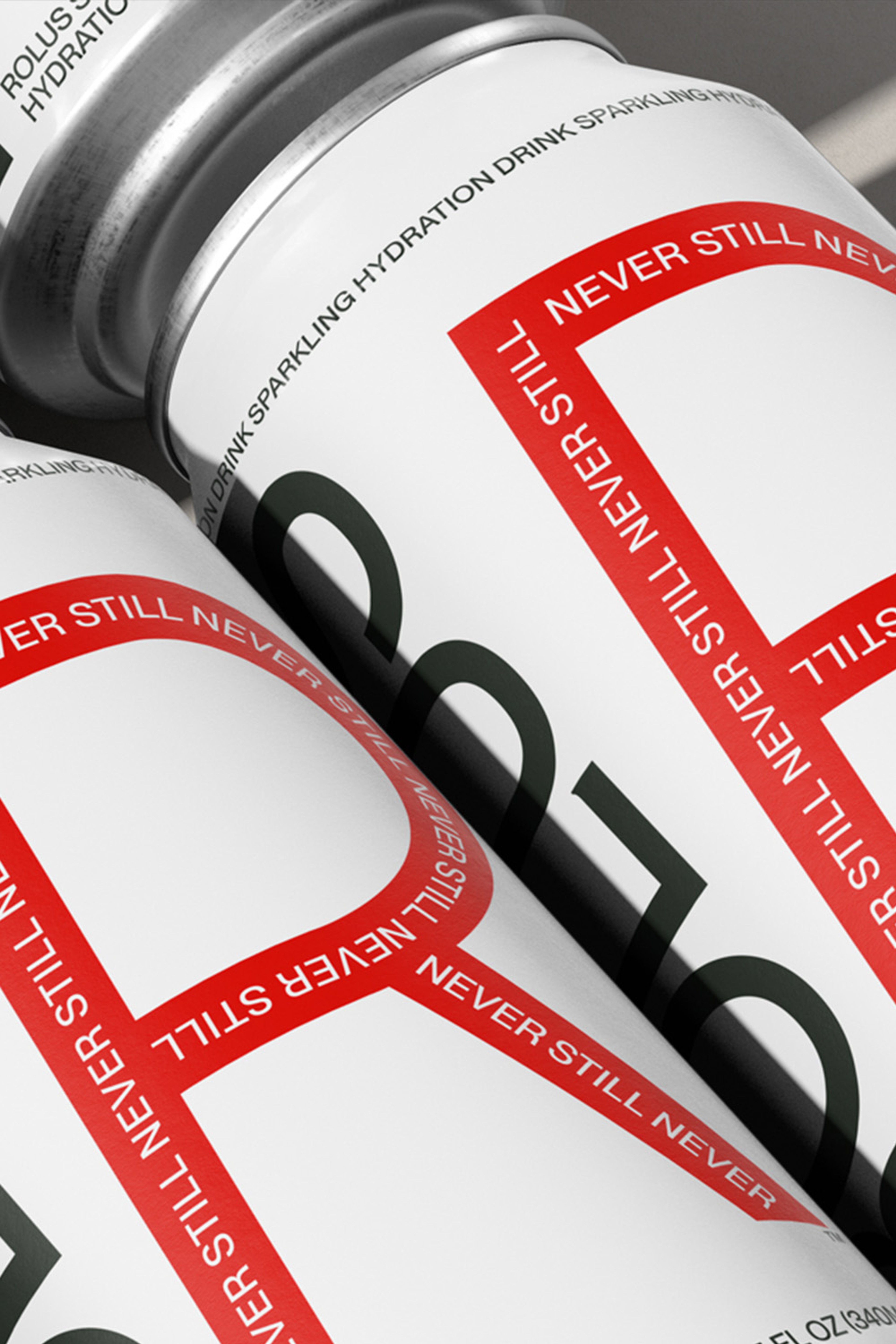 Macro of stacked cans showing the red R outlined in repeating Never Still lettering