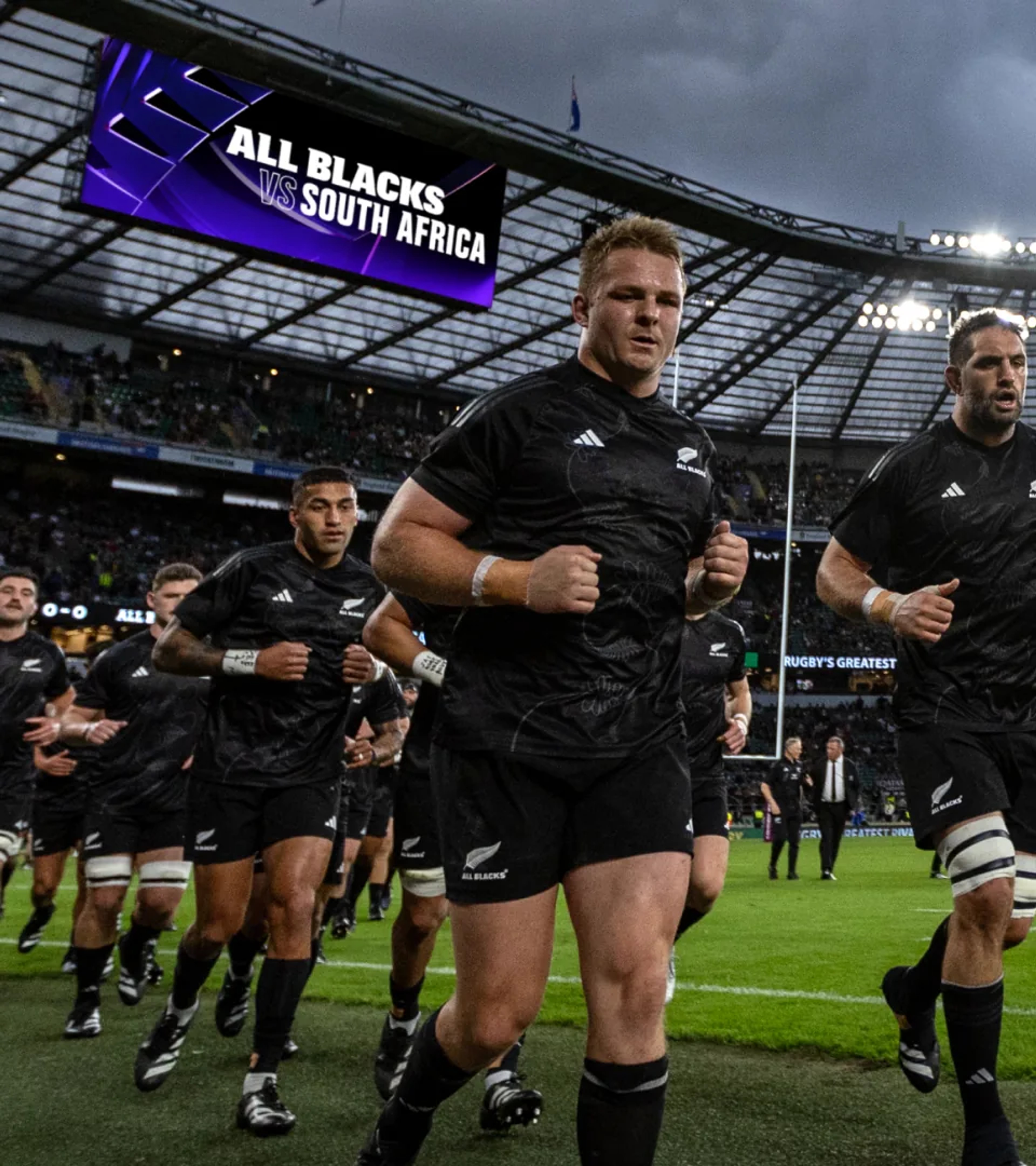 All Blacks running onto the pitch beneath a purple "All Blacks vs South Africa" screen