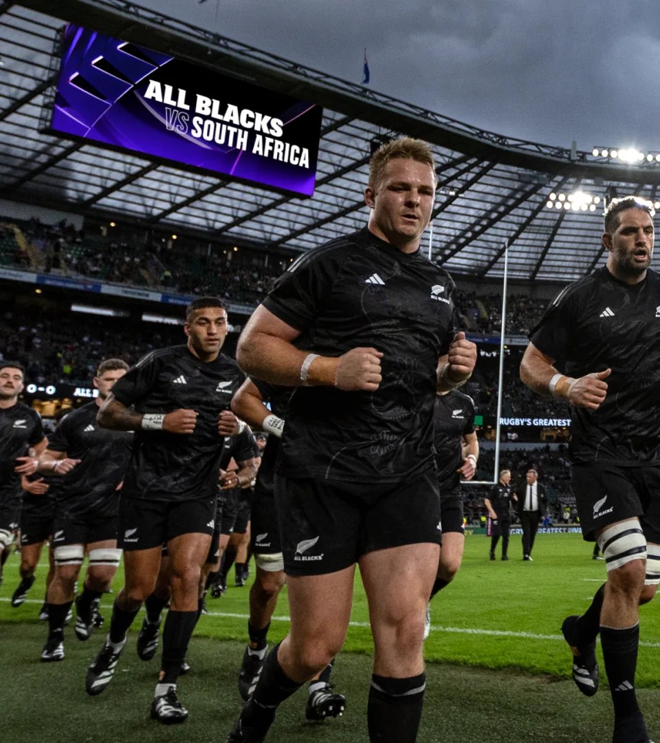 All Blacks running onto the pitch beneath a purple "All Blacks vs South Africa" screen