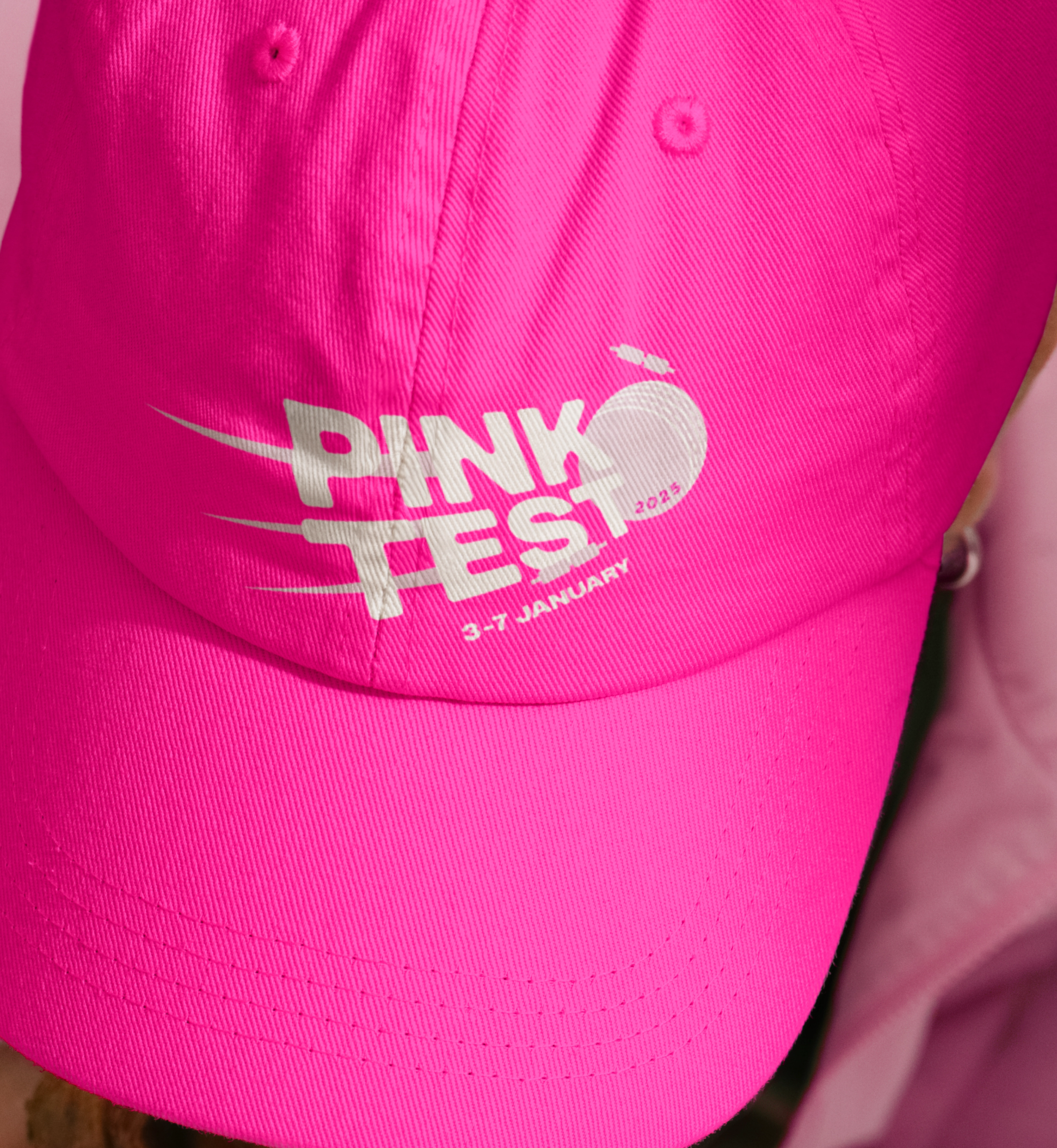 Hot pink cap embroidered with the Pink Test cricket-ball logo and its January dates