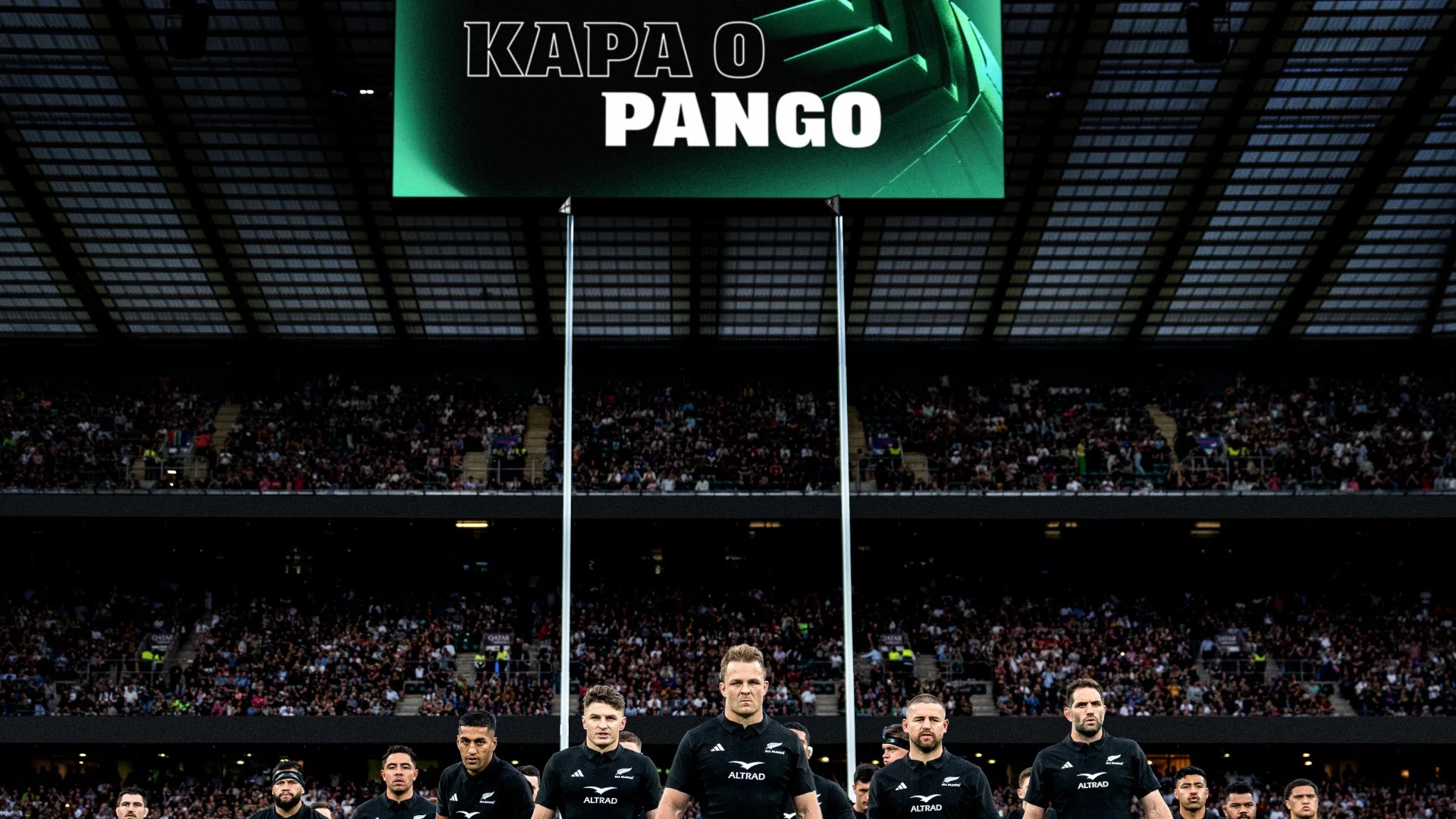 Stadium big screen reading "Kapa o Pango" above players lined up across the field