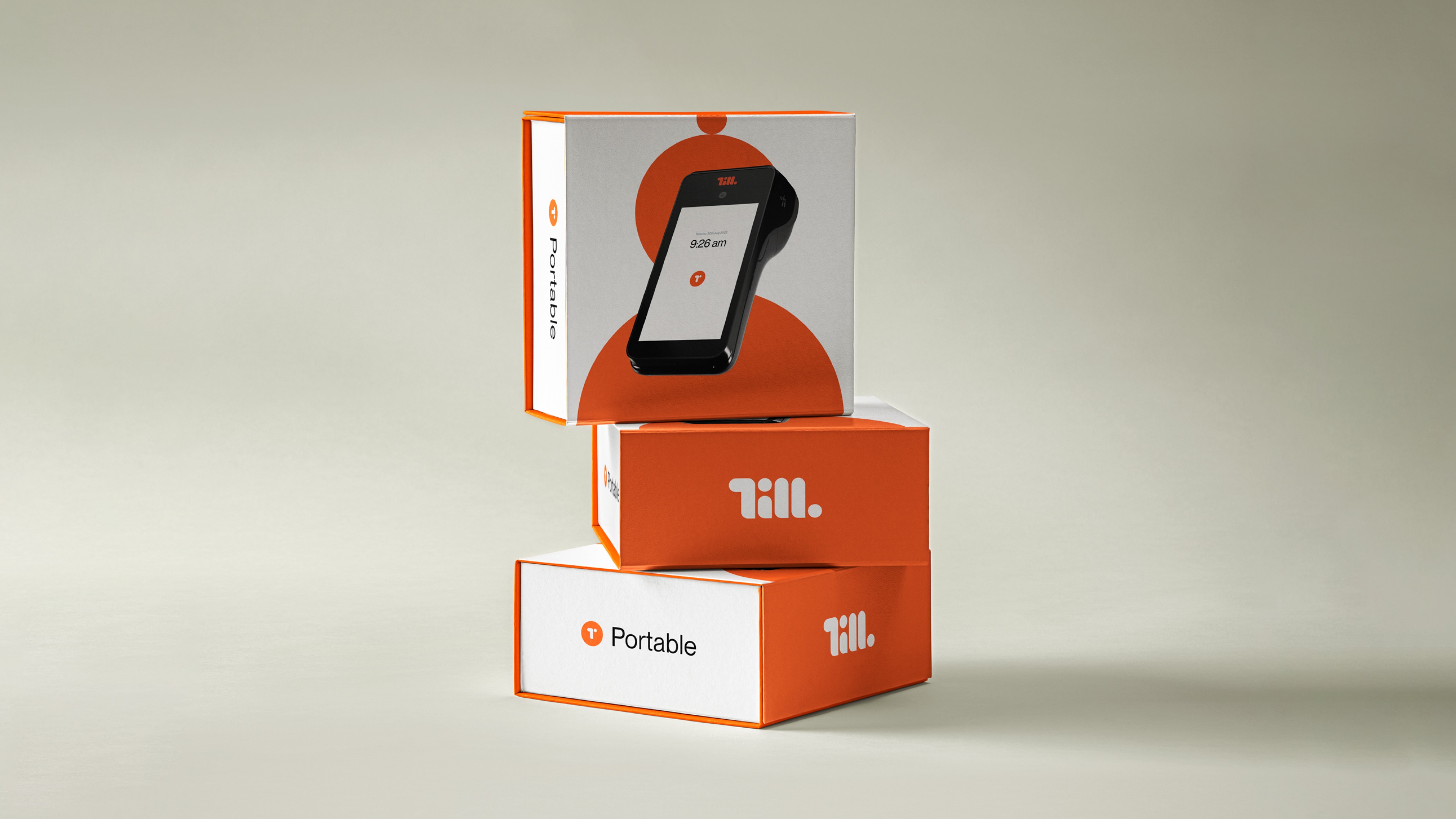 Orange Till Portable packaging boxes stacked, wordmark front and terminal shown through the window