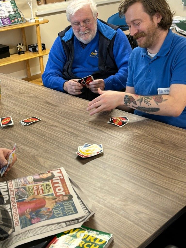 Men playing cards together in the Men's Shed support group