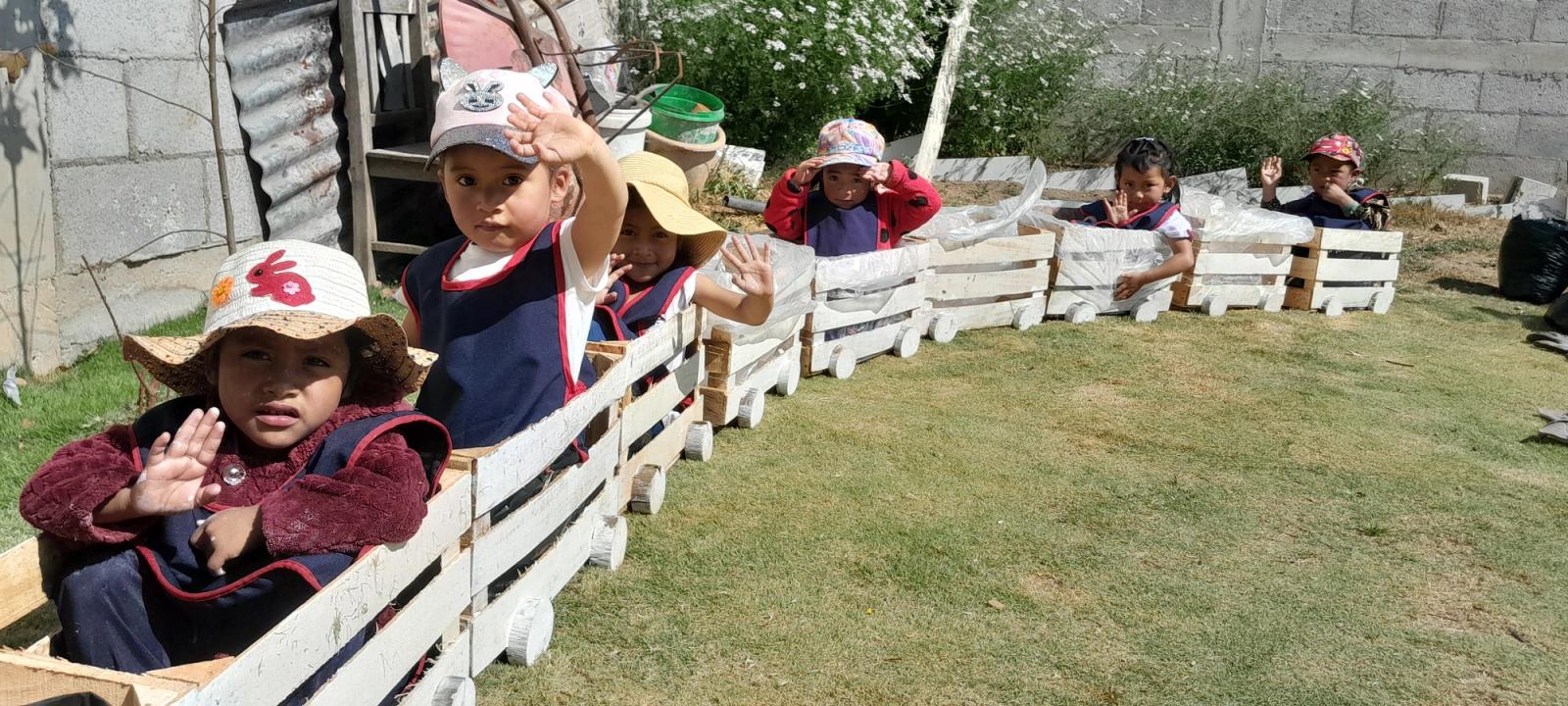 An open-air classroom in rural Guatemala, a facilitator teaching at the board