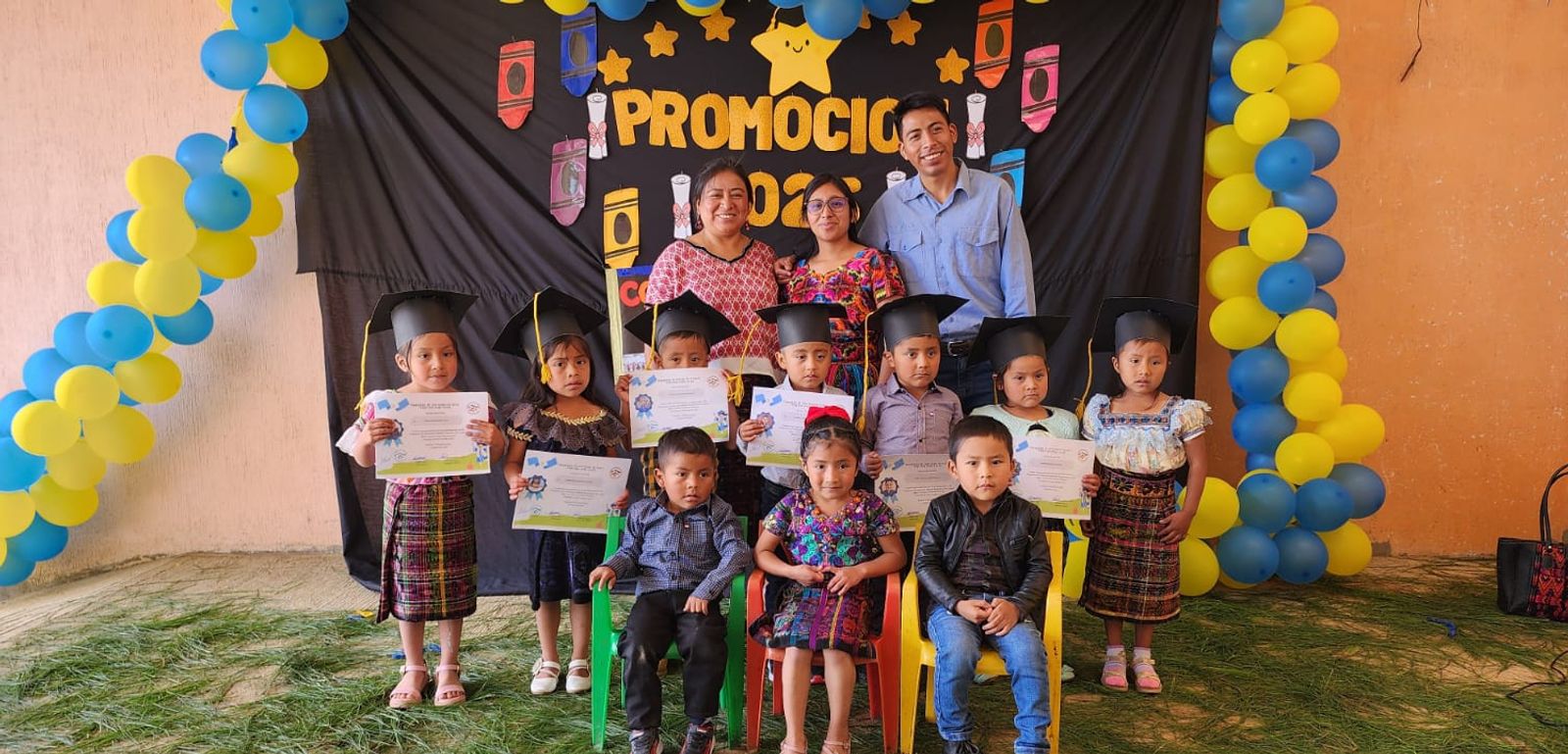 An open-air classroom in rural Guatemala, a facilitator teaching at the board