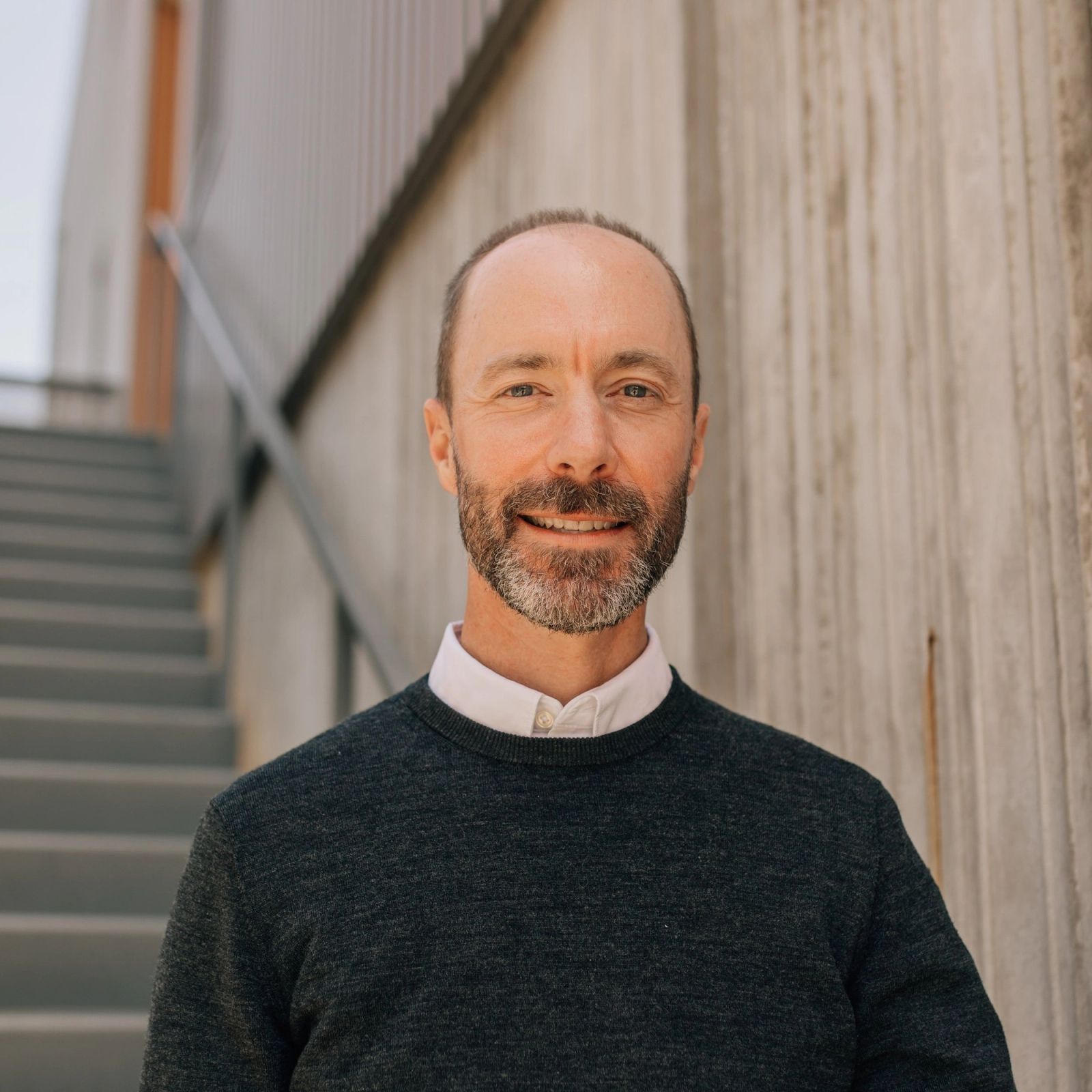 Todd standing in front of a set of stairs