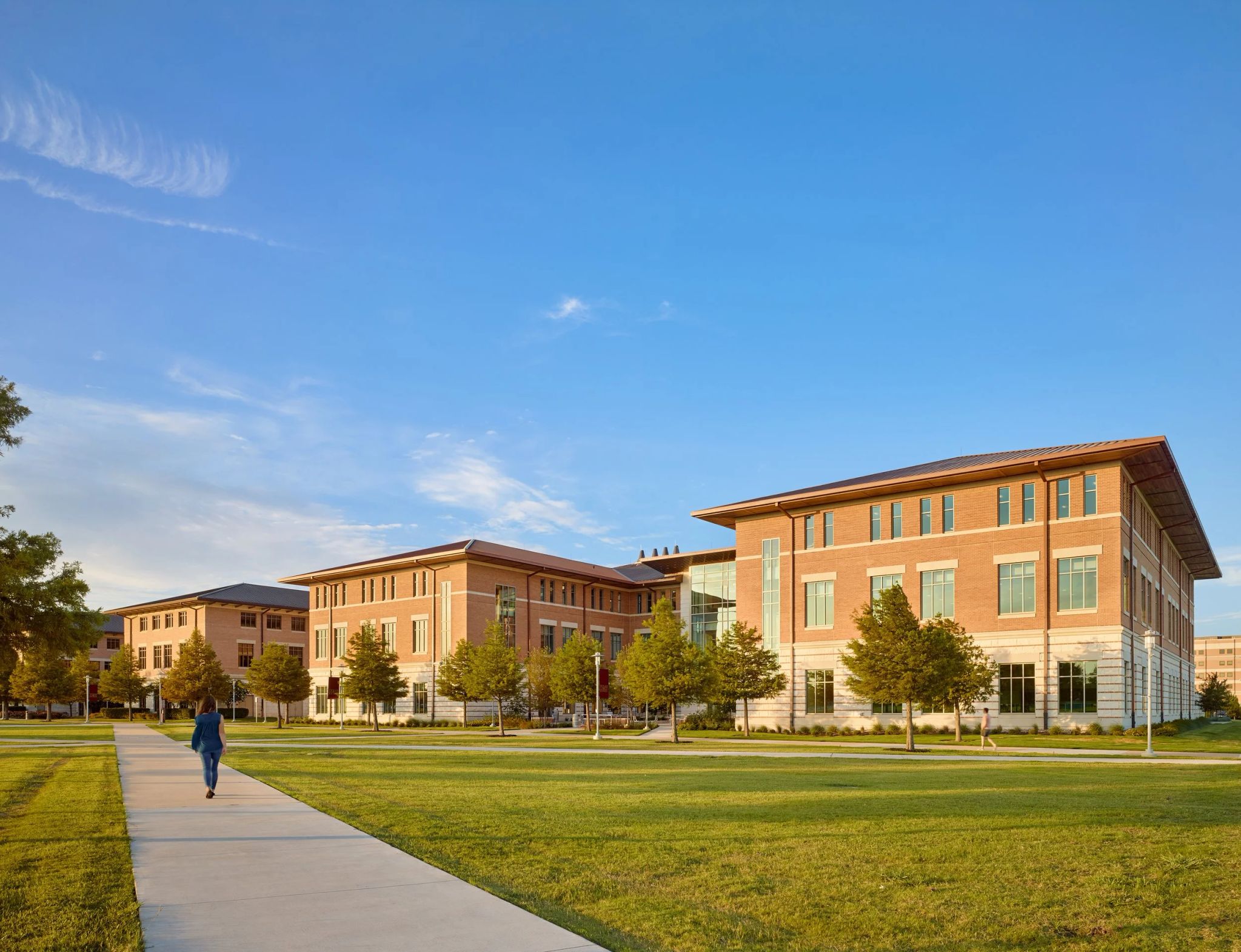 campus buildings with student walking