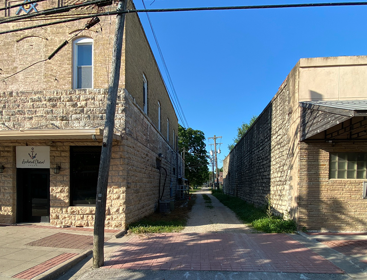looking down an alley between two historic buildings