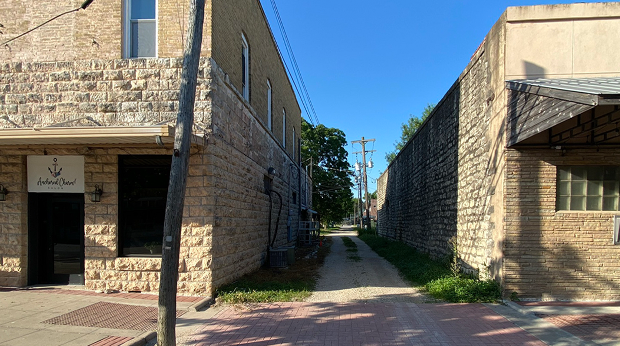 looking down an alley between two historic buildings