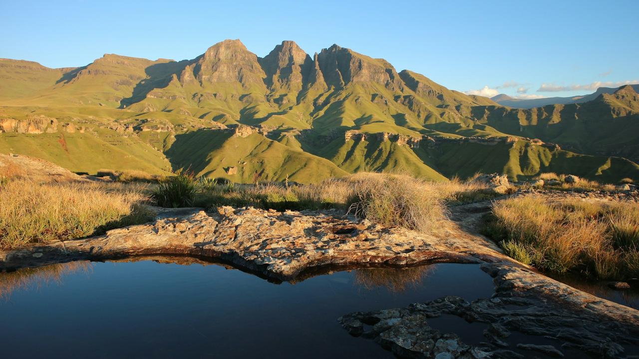 Drakensberg peaks above a rock pool in late afternoon light