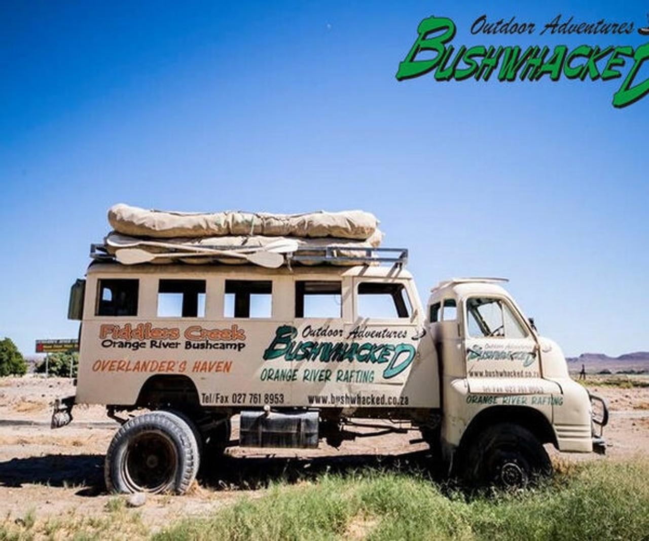 Bushwhacked Outdoor Adventures truck with rafts on the roof