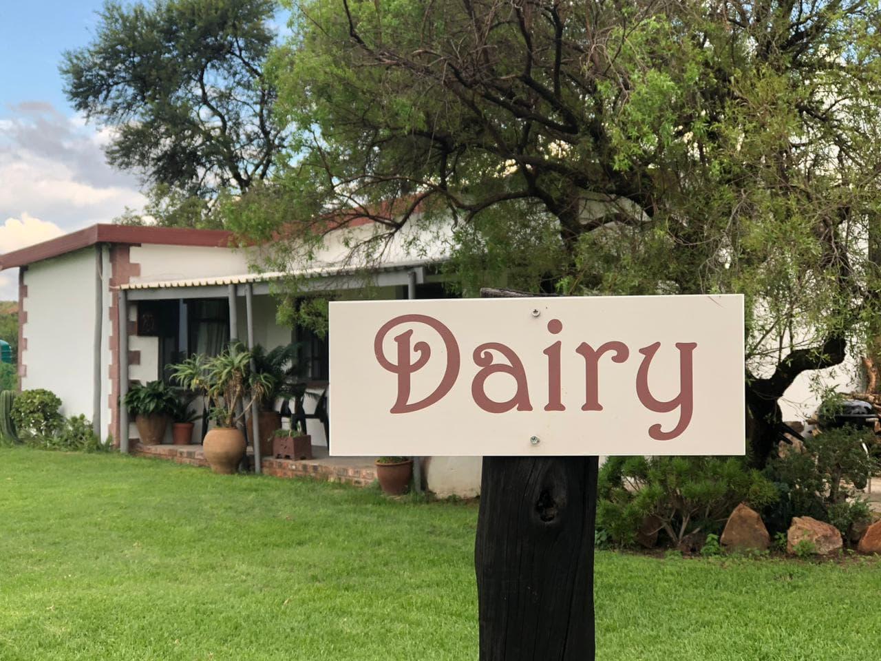 The Dairy cottage at Dikgomo Cottages near Cullinan, a whitewashed farm cottage with a covered stoep and a lawn in front