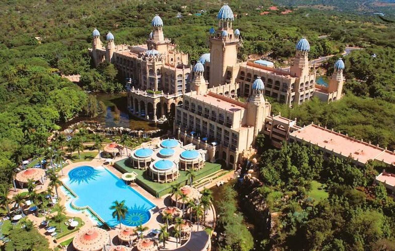 Aerial view of the Palace of the Lost City at Sun City, with its domed towers and a large pool set in green bush