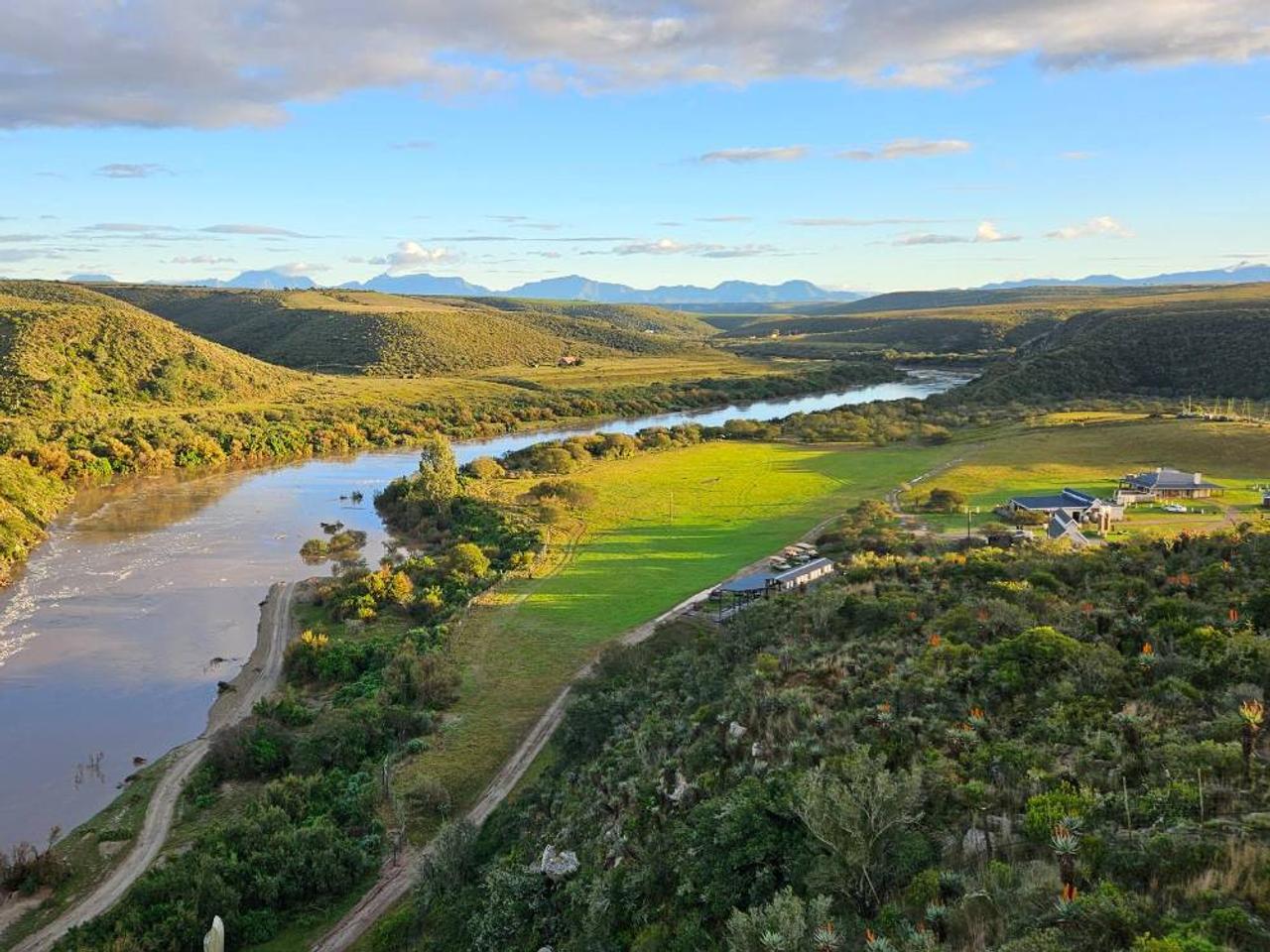 Aerial view of Bon Game Reserve near Mossel Bay, with the river, green fields and mountains in the distance