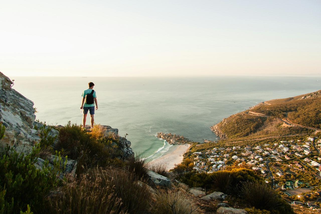 Hiker on a mountain ridge overlooking the coast in Cape Town
