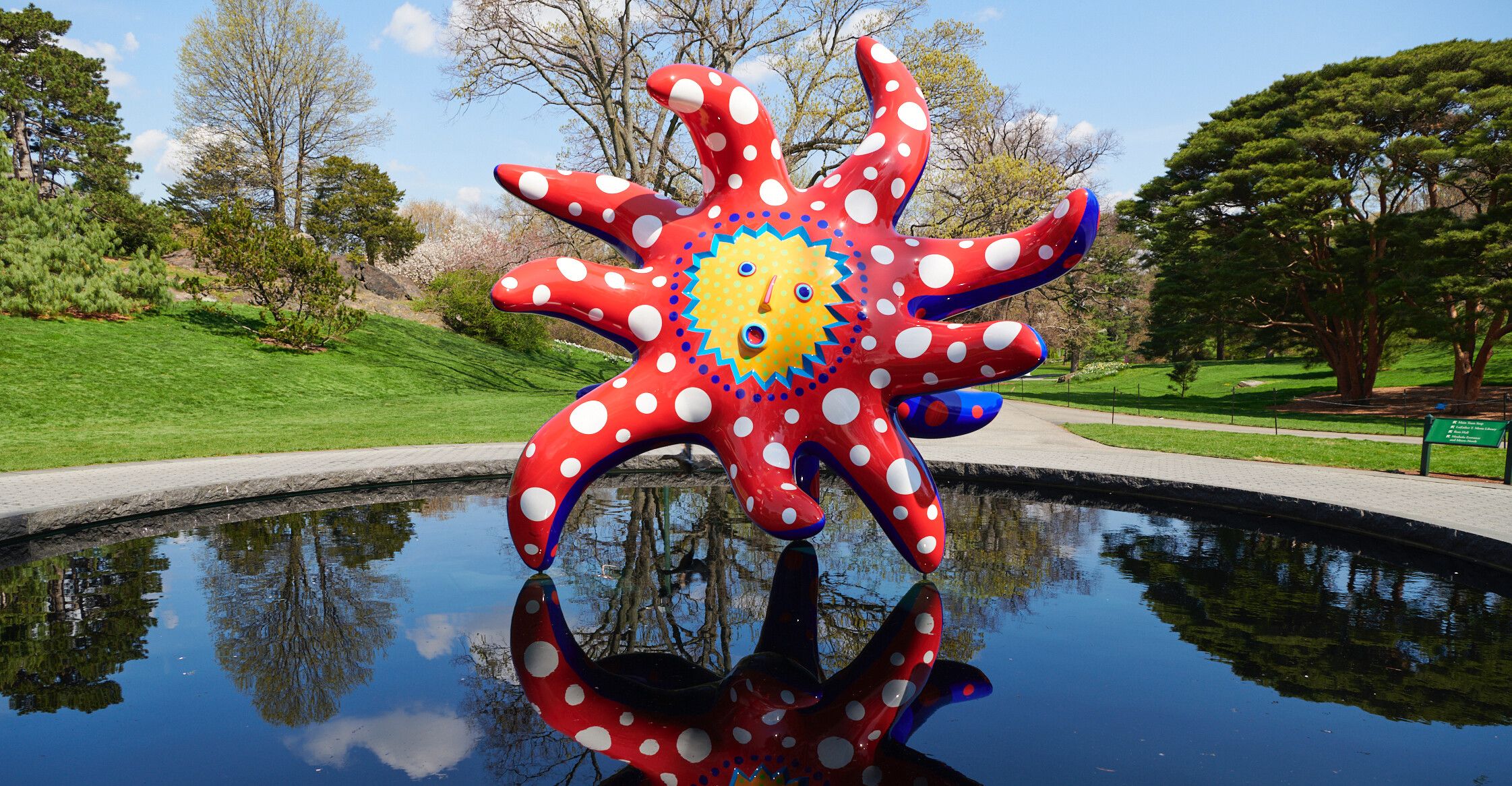 An installation view of an exhibition titled Kusama: Cosmic Nature at New York Botanical Garden in 2021.