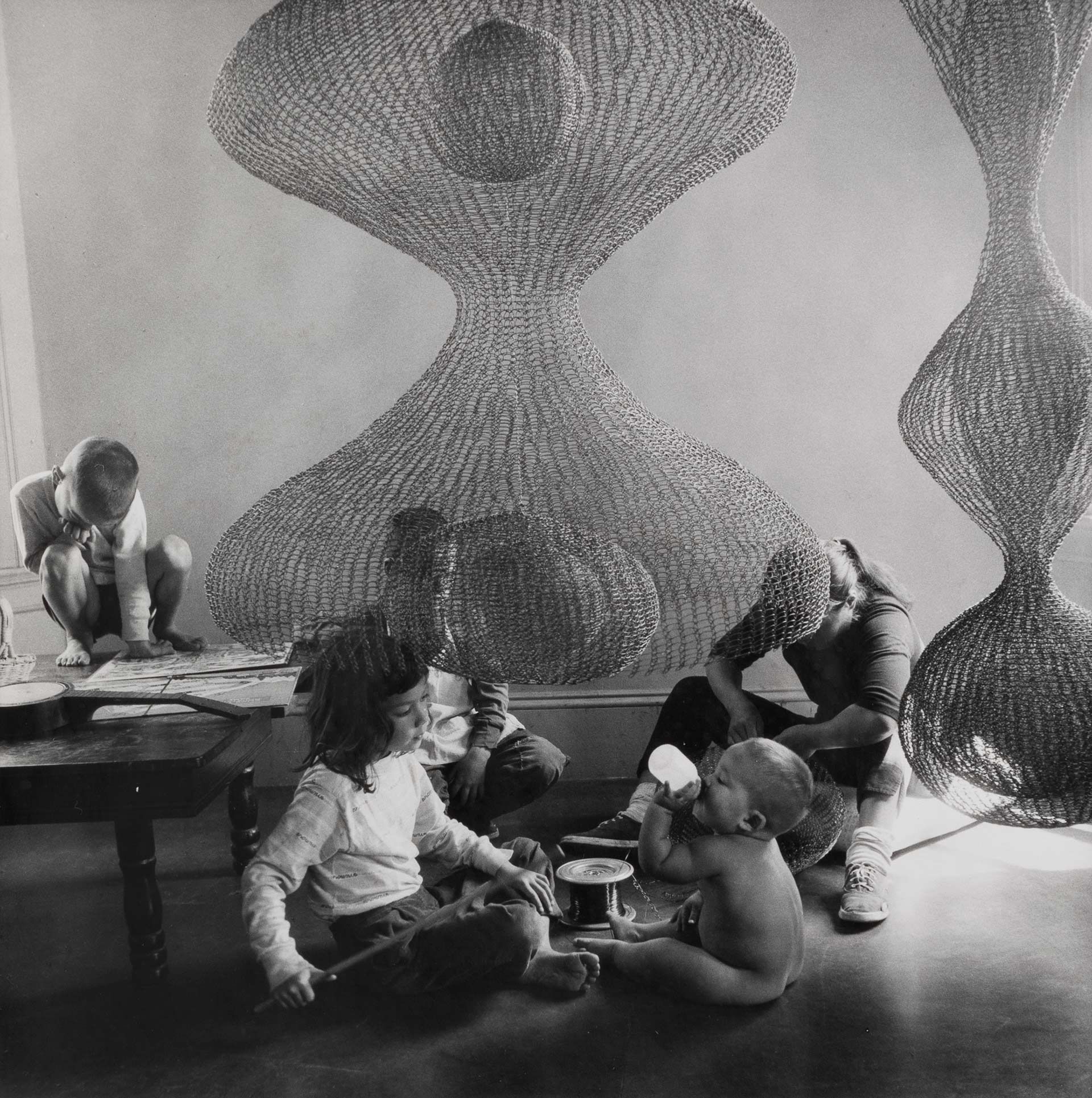 A photo of Ruth Asawa, Sculptor, and Her Children, dated 1957. Photo by Imogen Cunningham.