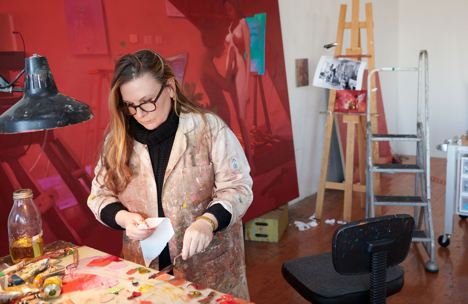 A photograph of Lisa Yuskavage in her studio, dated 2020