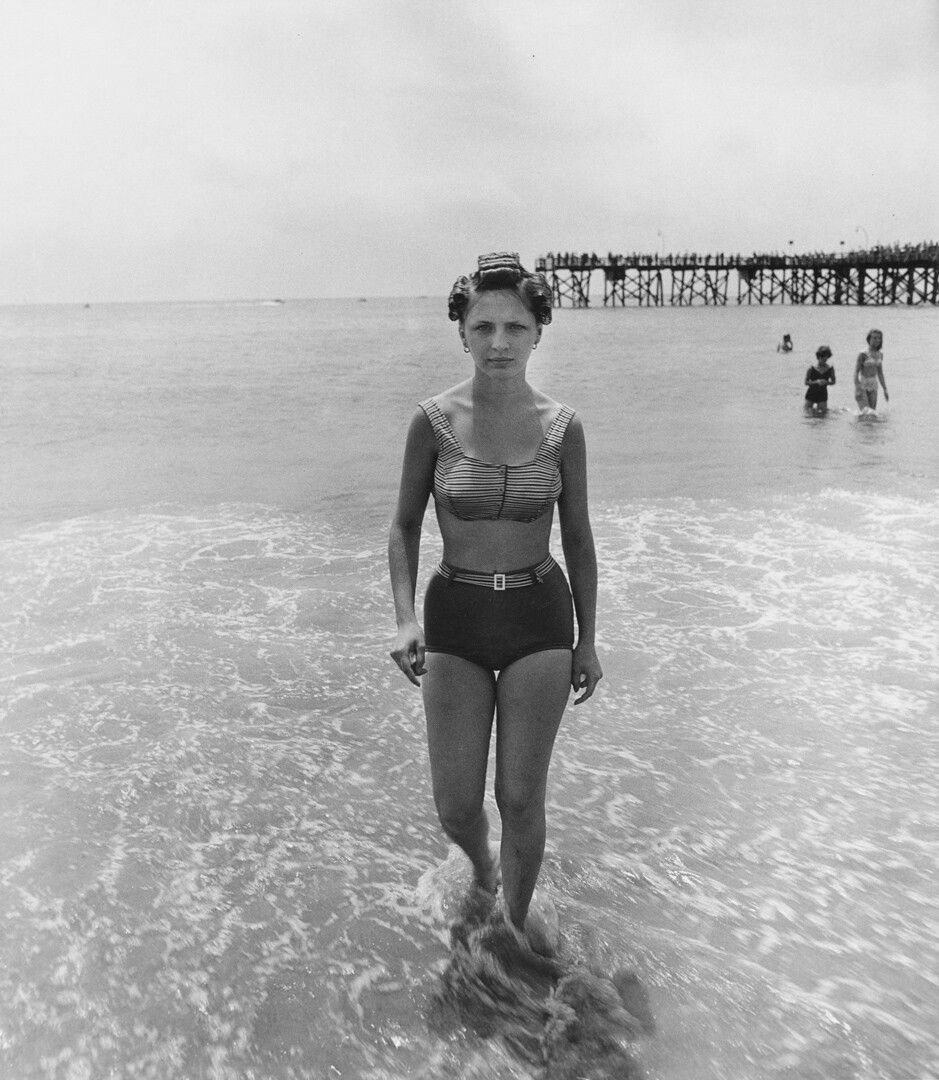 A gelatin silver print by Diane Arbus, titled Girl emerging from the ocean in curlers, Coney Island, N.Y. 1963, dated 1963.