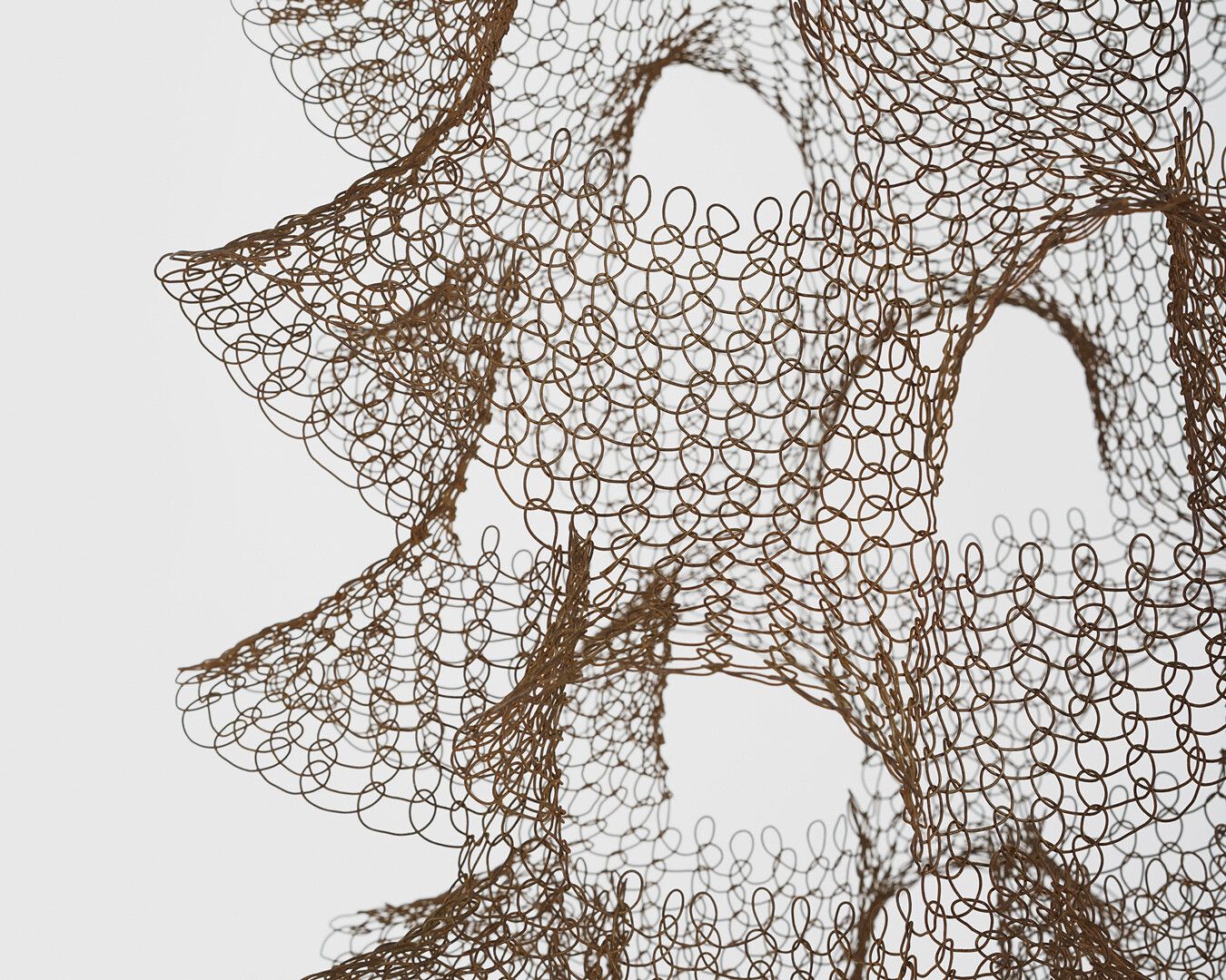 A detail of a hanging steel wire sculpture by Ruth Asawa, titled, Untitled (S.786, Hanging Two-Sectioned, Open-Window Form), circa 1950 to 1959.