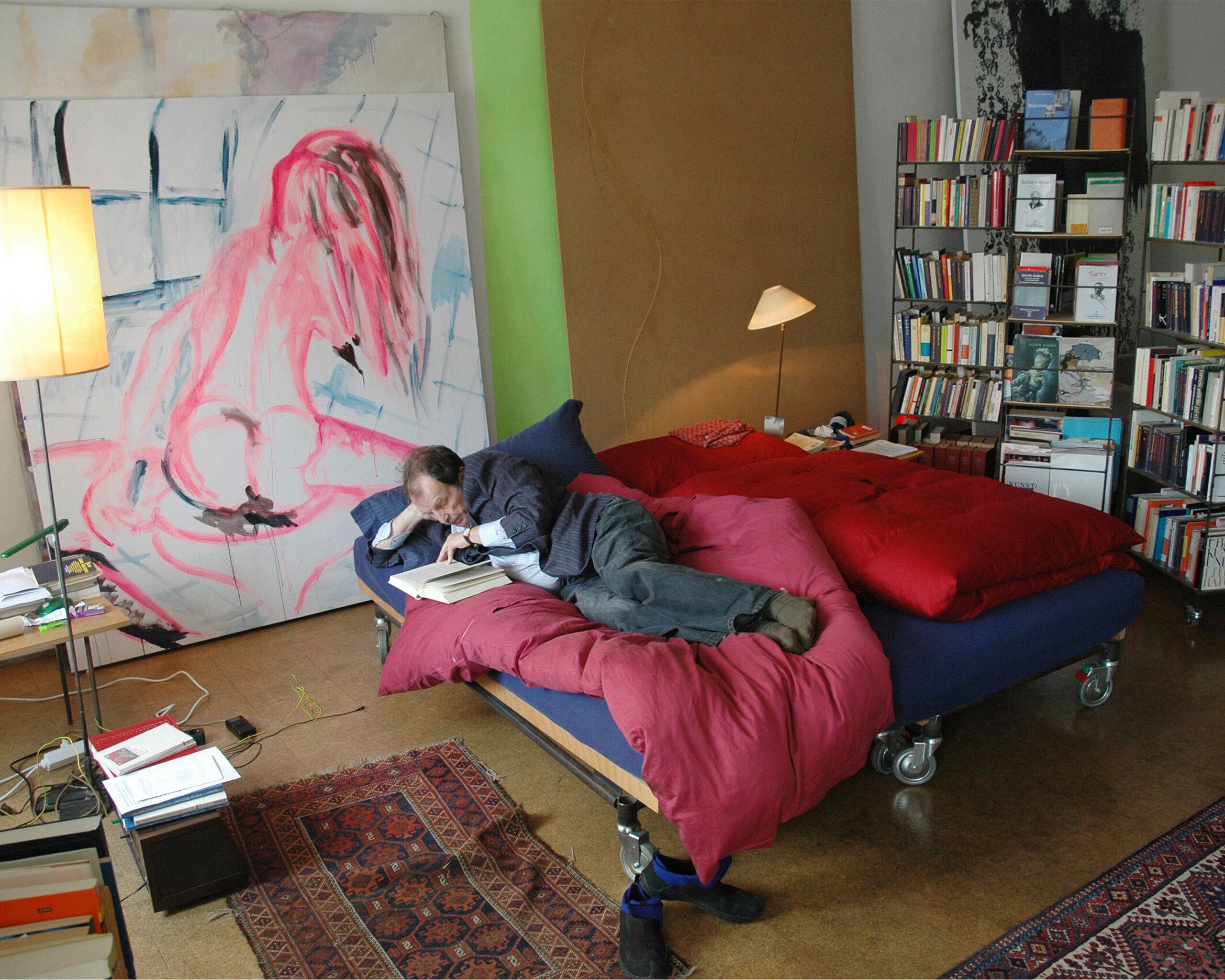 West in his bedroom with a slightly larger version of a bookshelf in the form and style of his edition for Parkett