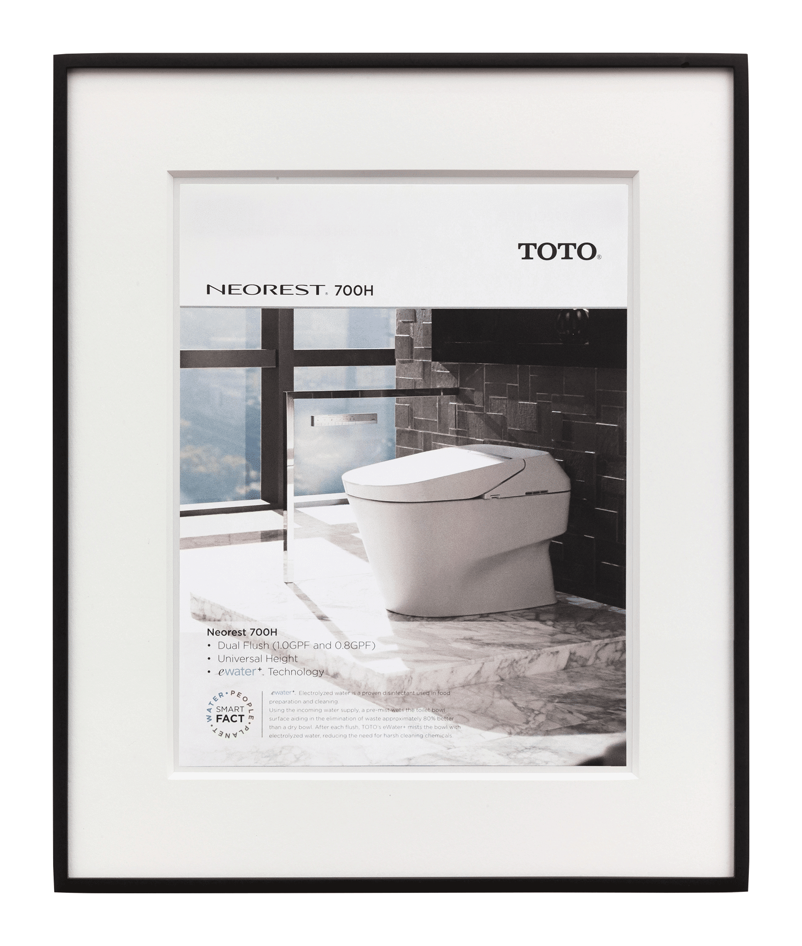 A framed advertisement. The ad features a photo of a tankless toilet on a marble platform. Text in the ad reads, “TOTO, NEOREST 700H, Dual Flush, Universal Height, eWater Technology.” Near the bottom is a circular logo that says, “SMART FACT, WATER, PEOPLE, PLANET” with an additional paragraph of copy.