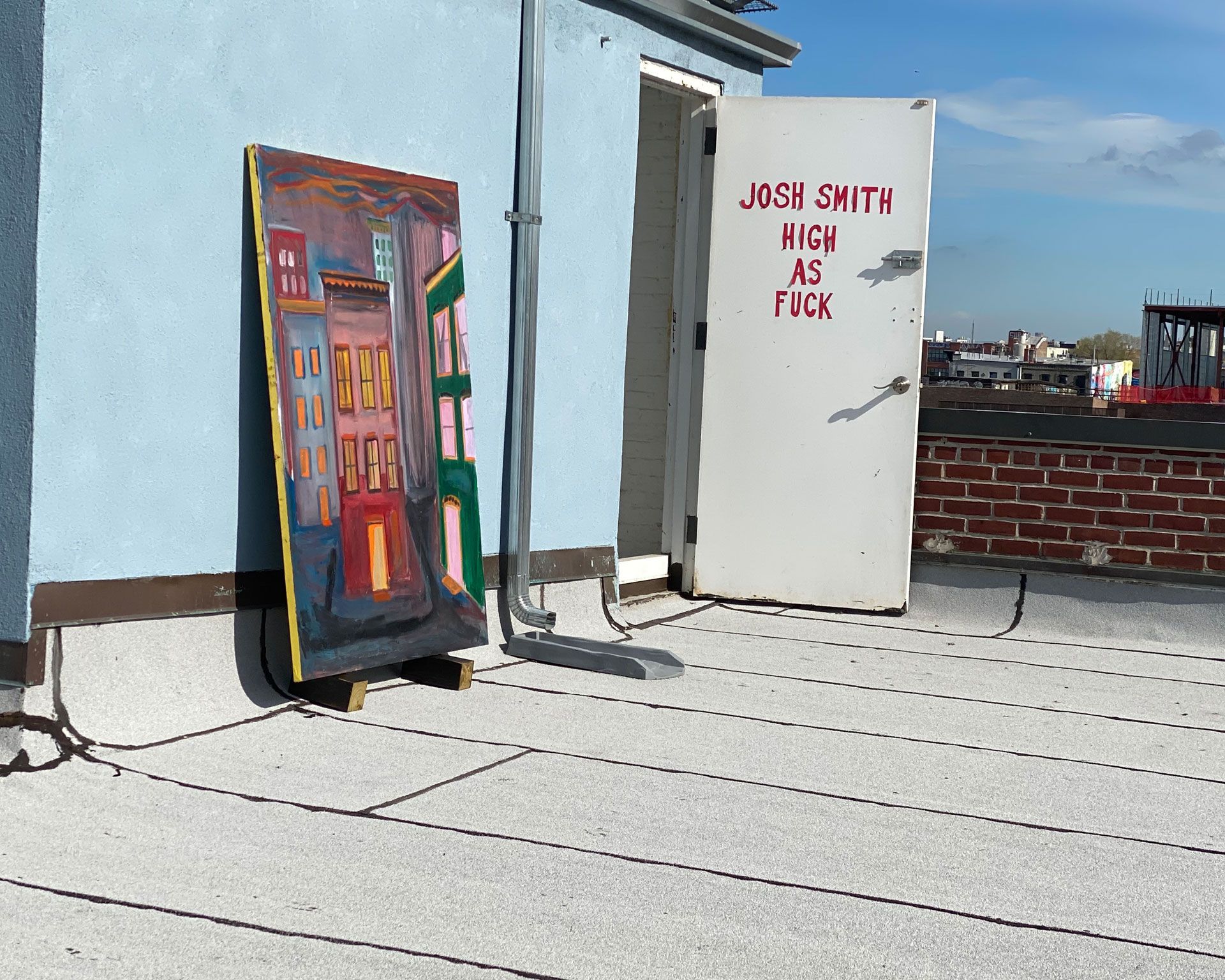 An installation view of the exhibition titled Josh Smith: High As Fuck on the artist's studio roof in Brooklyn, New York, dated 2020.