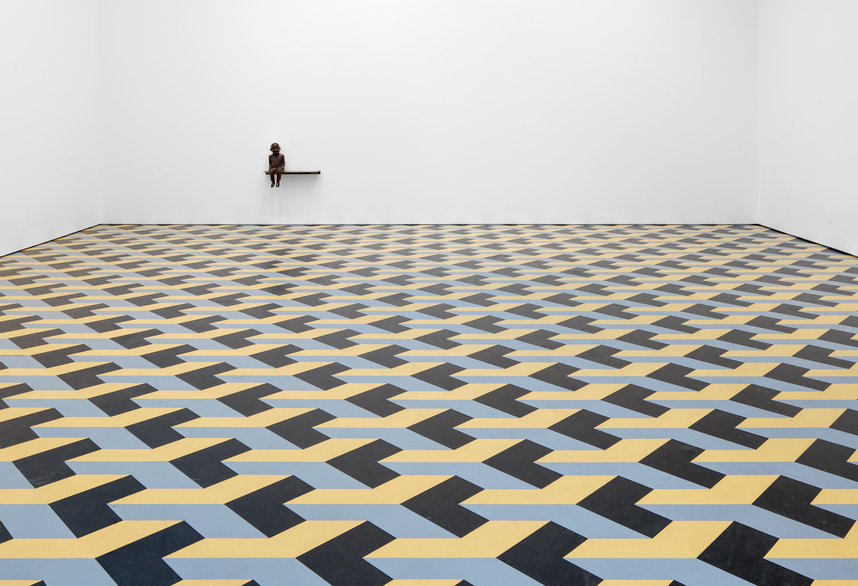 A bronze, steel, and linoleum installation by Juan Muñoz, titled The Wasteland, dated 1986.