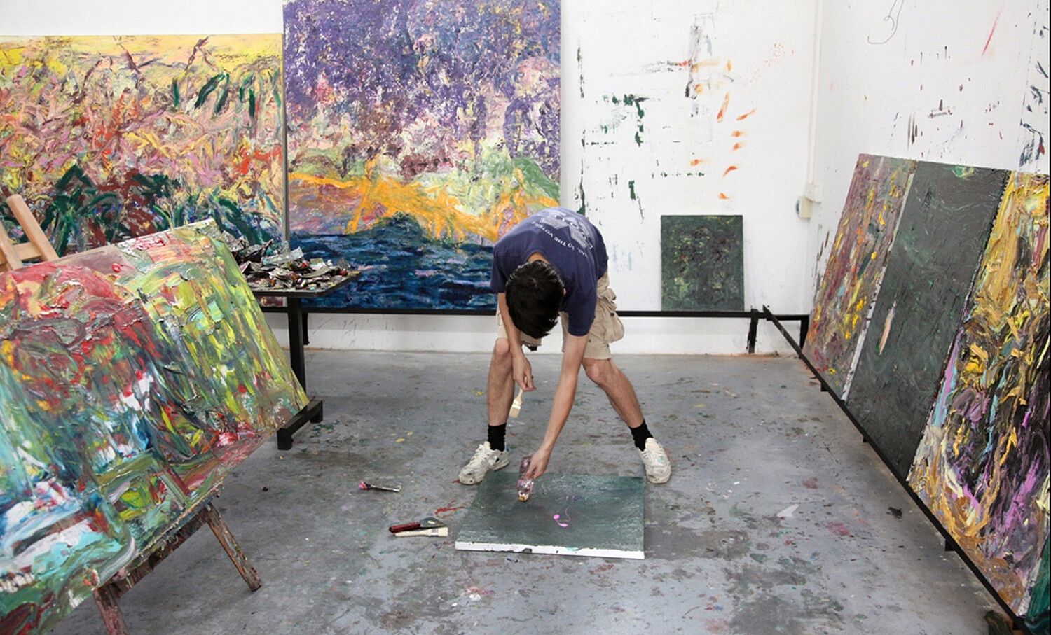 A photo featuring Matthew Wong working in his studio, dated 2014.