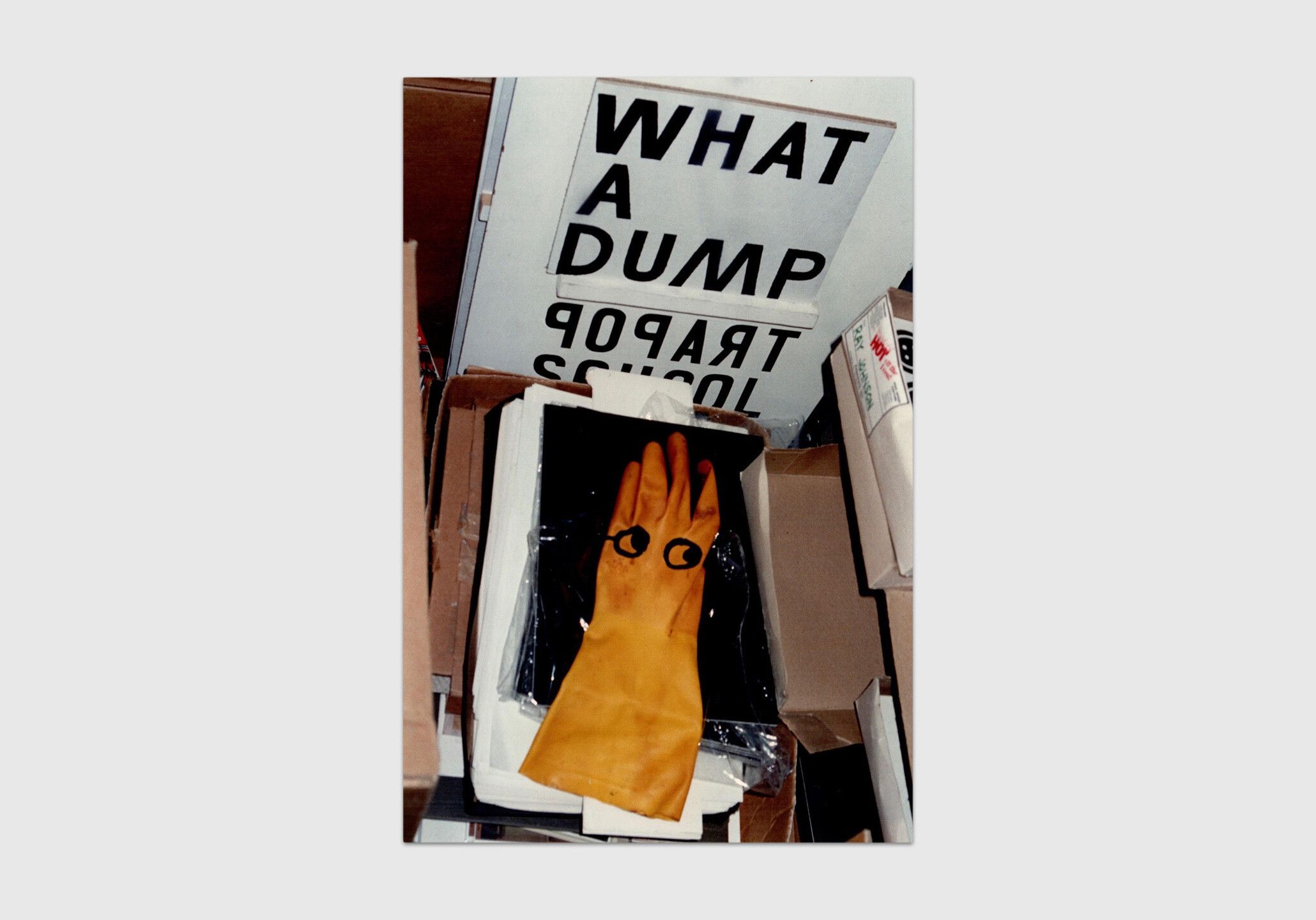 An undated color photograph by Frances Beatty, titled Untitled (WHAT A DUMP glove).