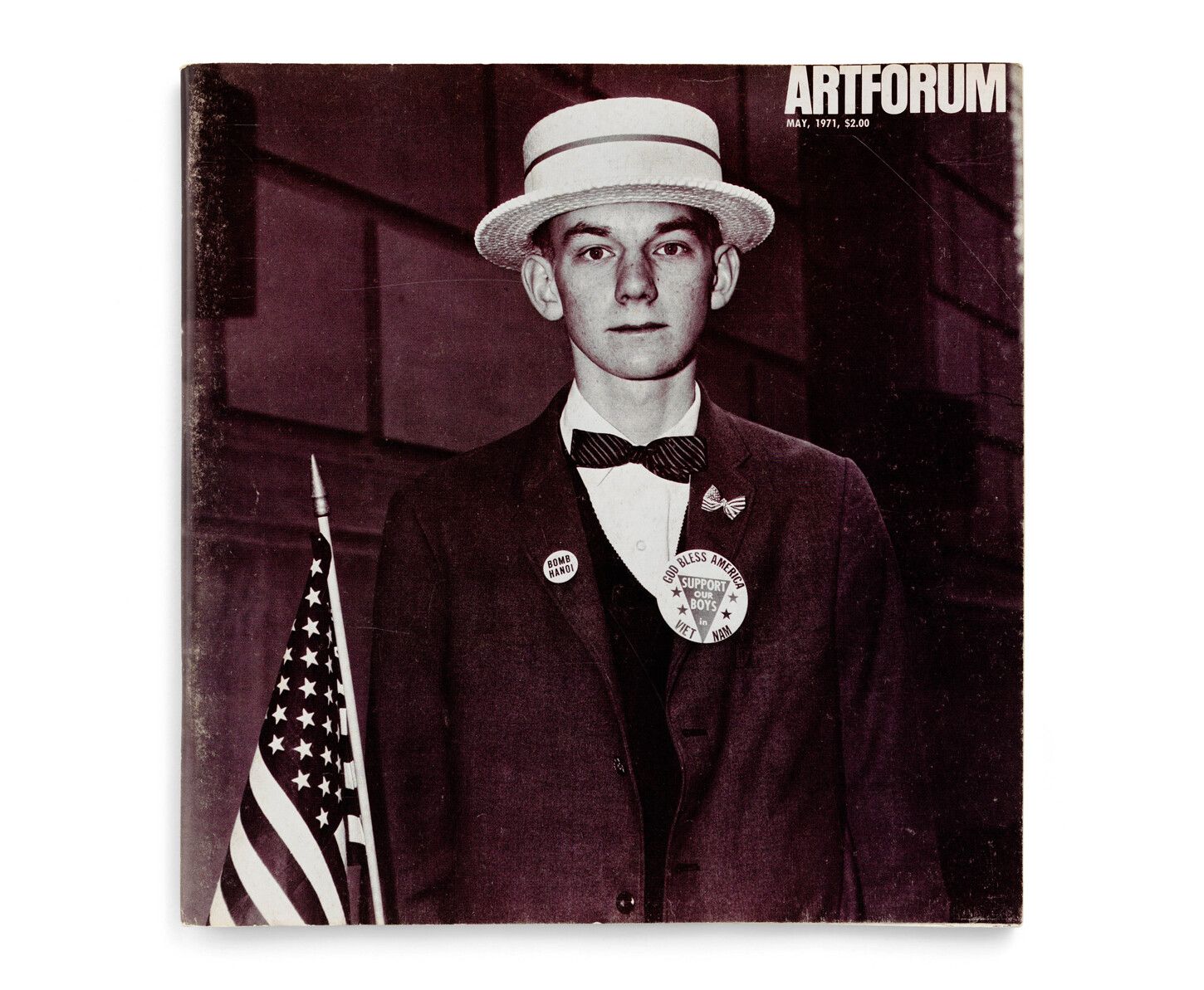 An image of a boy with a straw hat waiting to march in a pro-war parade by Diane Arbus, cover of Artforum, dated May 1971