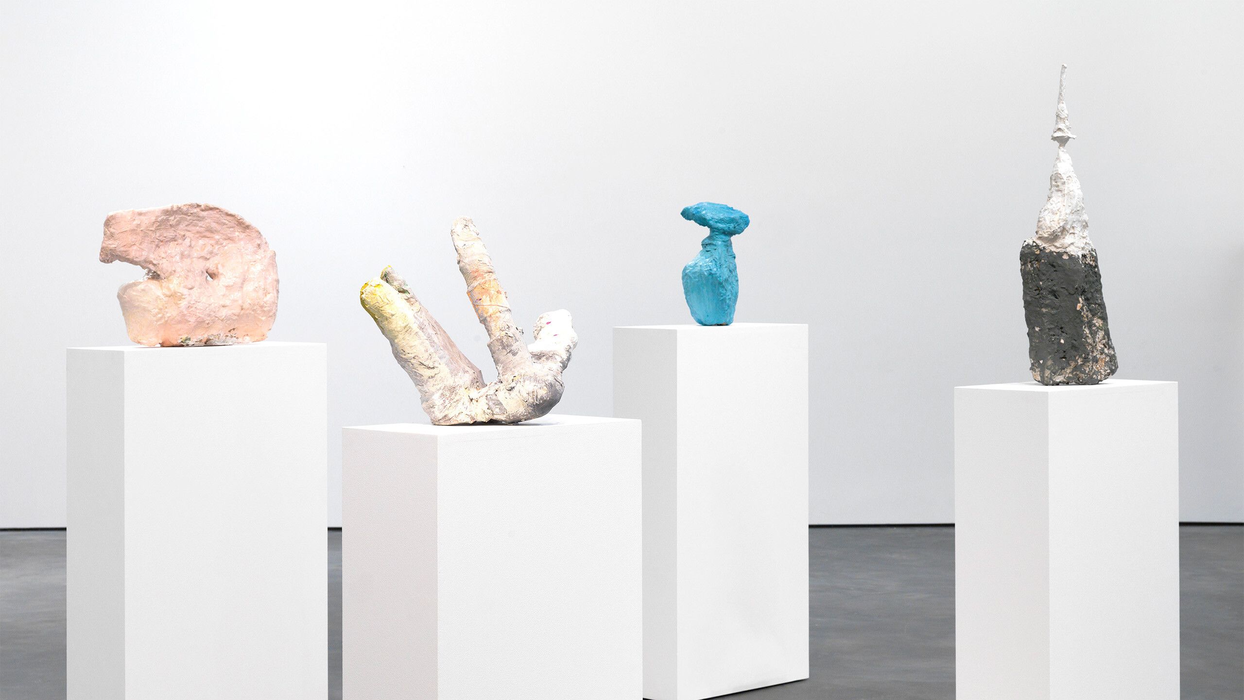A photo of a sculpture by Franz West, titled "2 to 2 (do too 2 [too do 2 {to do two}])", dated 1998