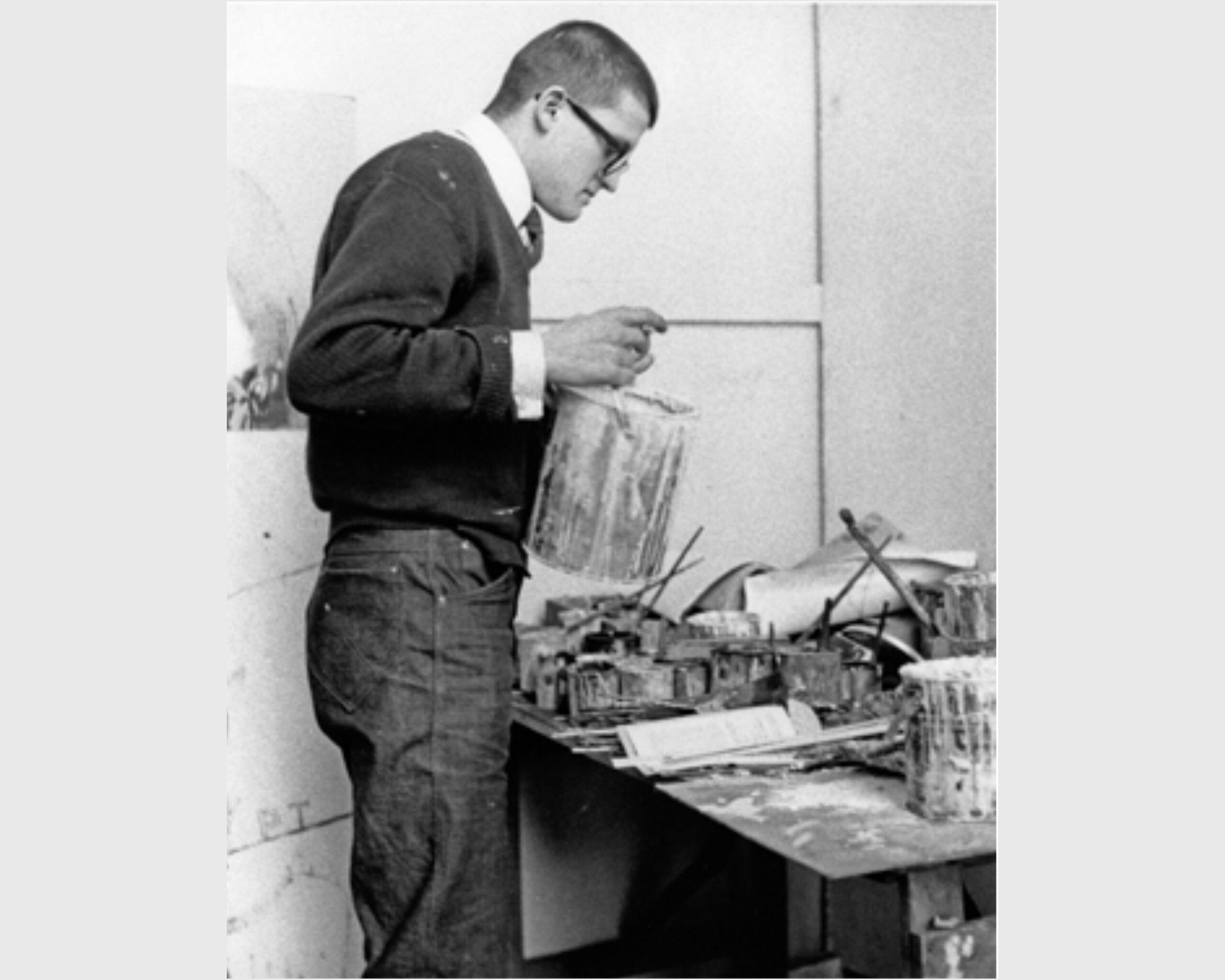 A photograph of David Hockney in his studio at The Royal College of Art in London, dated early 1960s