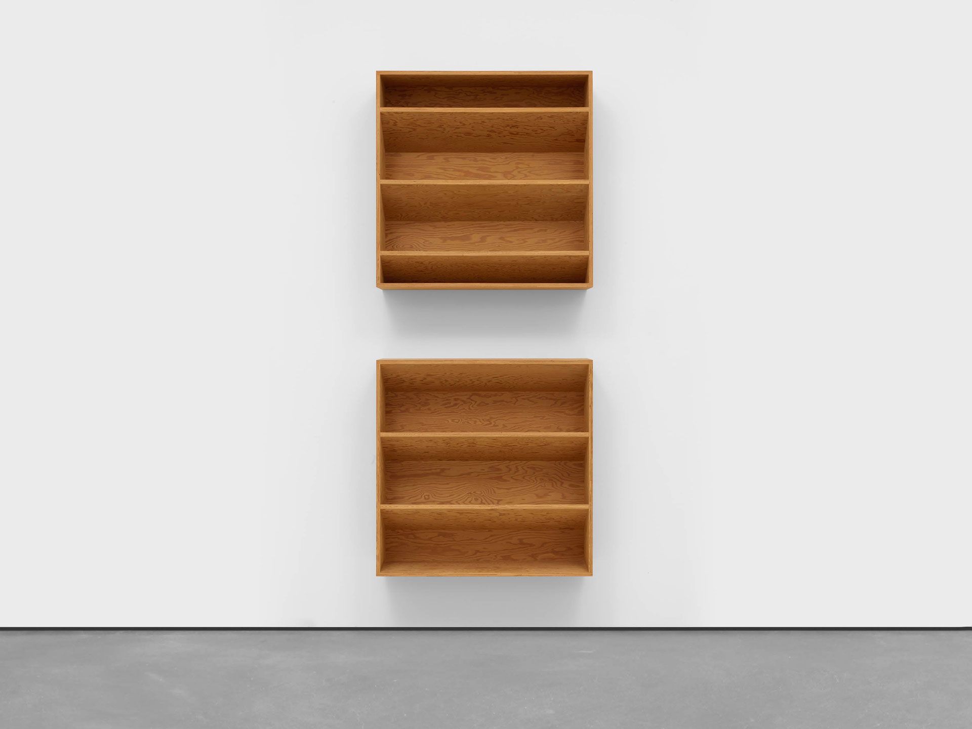 An untitled douglas fir plywood sculpture comprised of two units by Donald Judd, dated 1984.