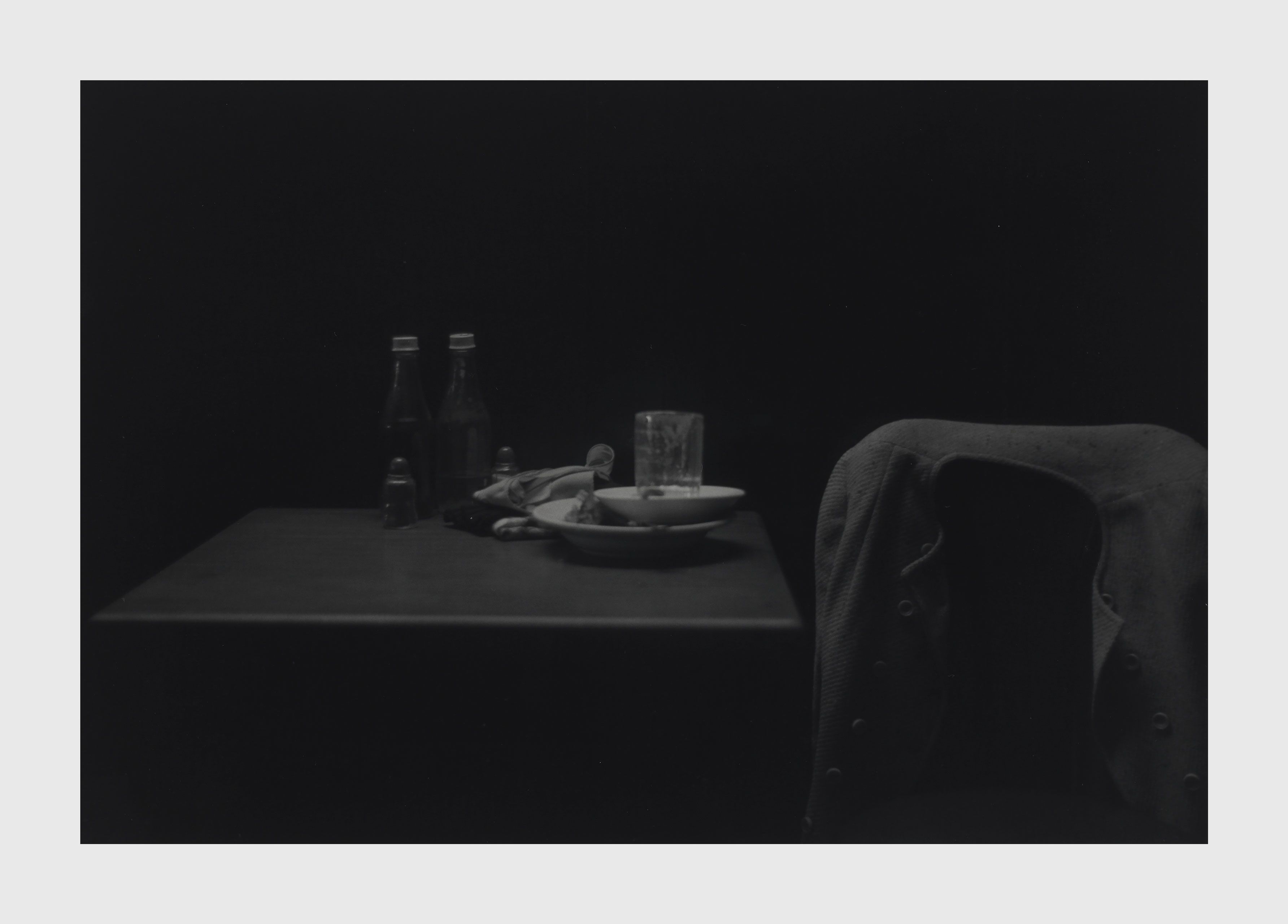 A silver gelatin print by Roy DeCarava, titled Catsup bottles, table and coat, dated 1952.