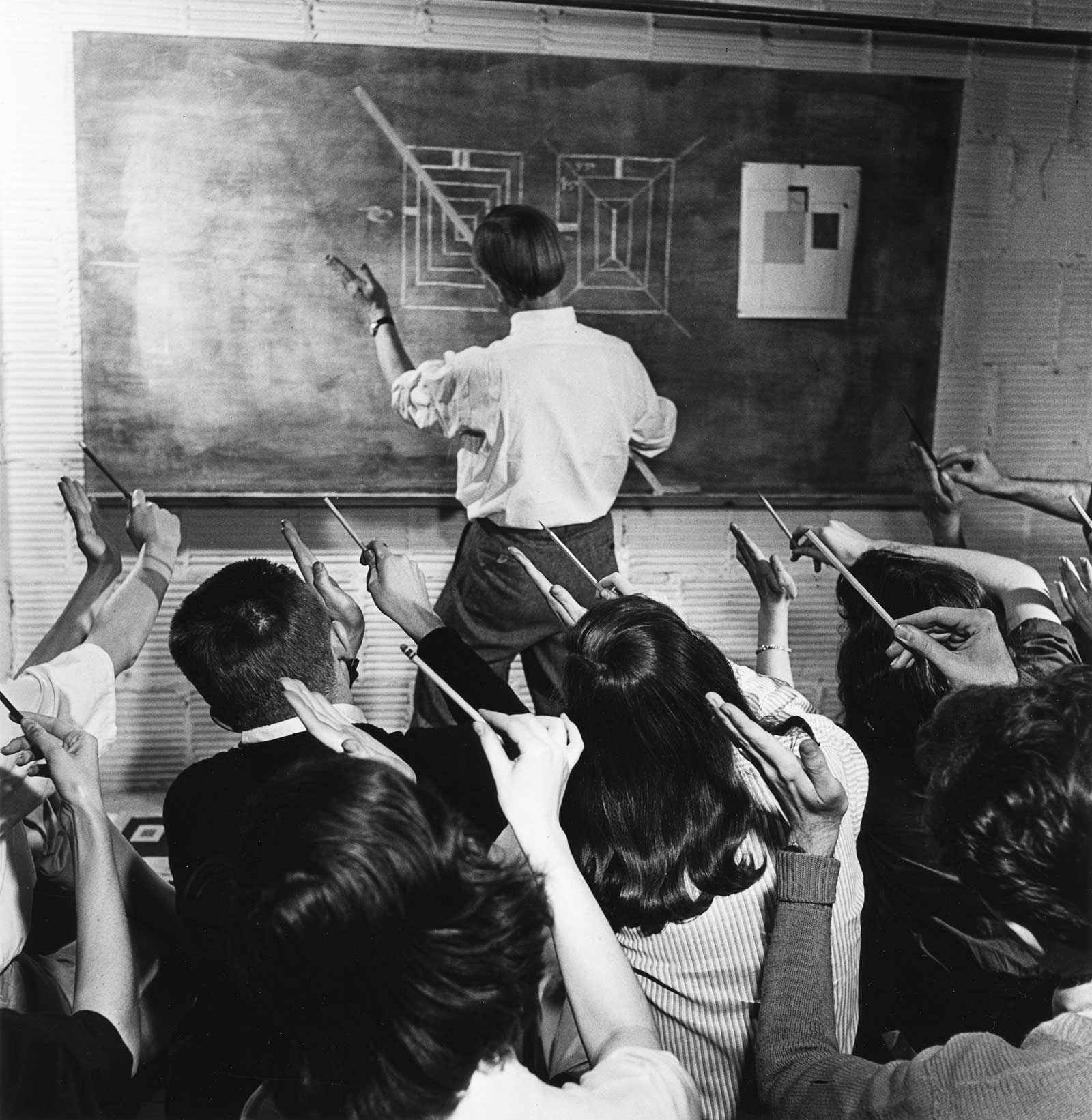 A photograph of Josef Albers teaching students at Black Mountain College.