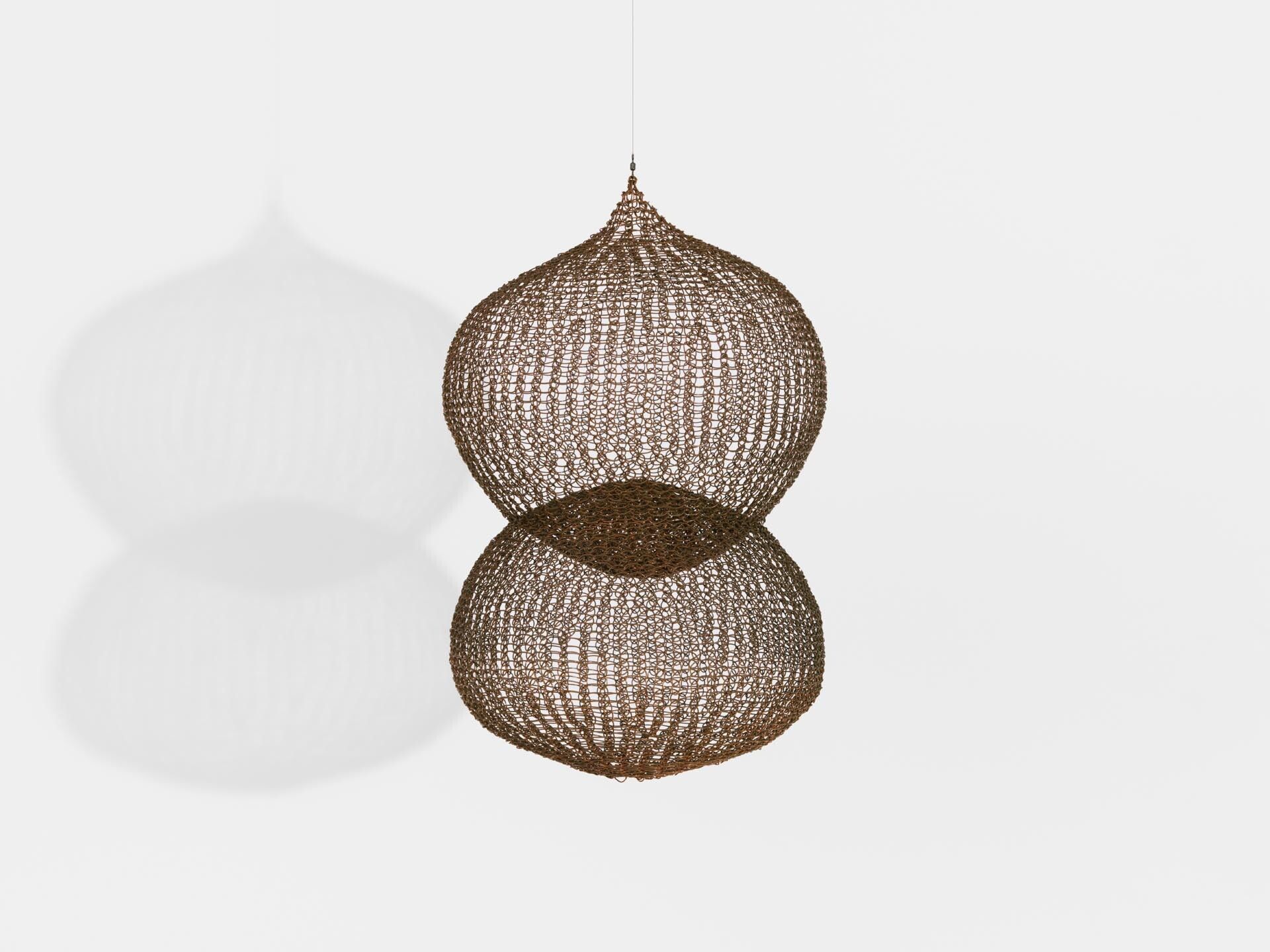 A sculpture by Ruth Asawa, titled Untitled (S.015, Hanging, Two Interlocked Spheres with a Small Sphere in the Center), dated circa 1980 to 1989.