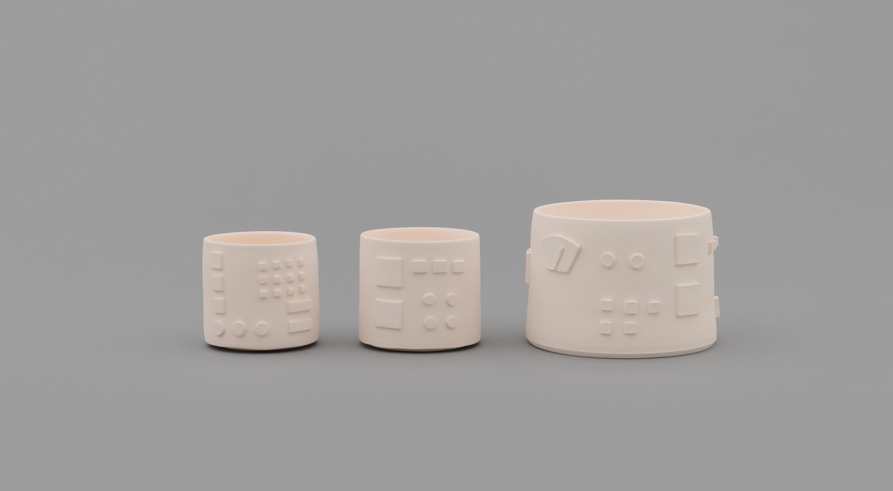 A three part porcelain artwork by Shio Kusaka, titled (machine 2), dated 2021.
