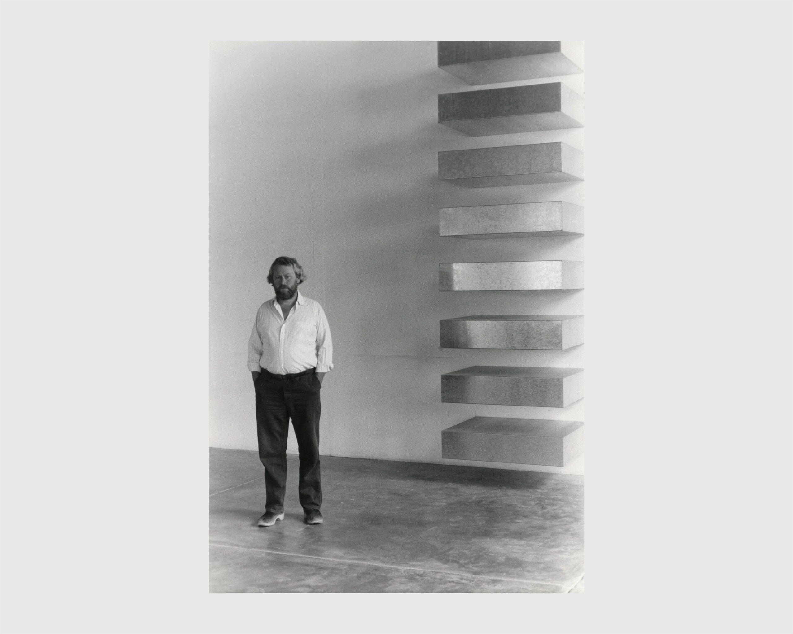A photo of Donald Judd with his work in 1982.