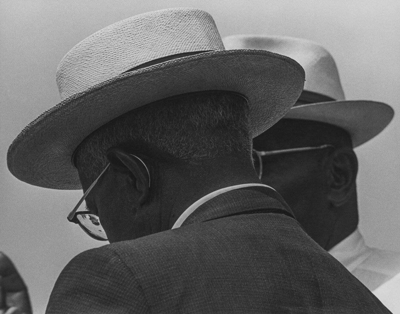 A silver gelatin print by Roy DeCarava, titled Two men talking, Washington, D.C., dated 1963.